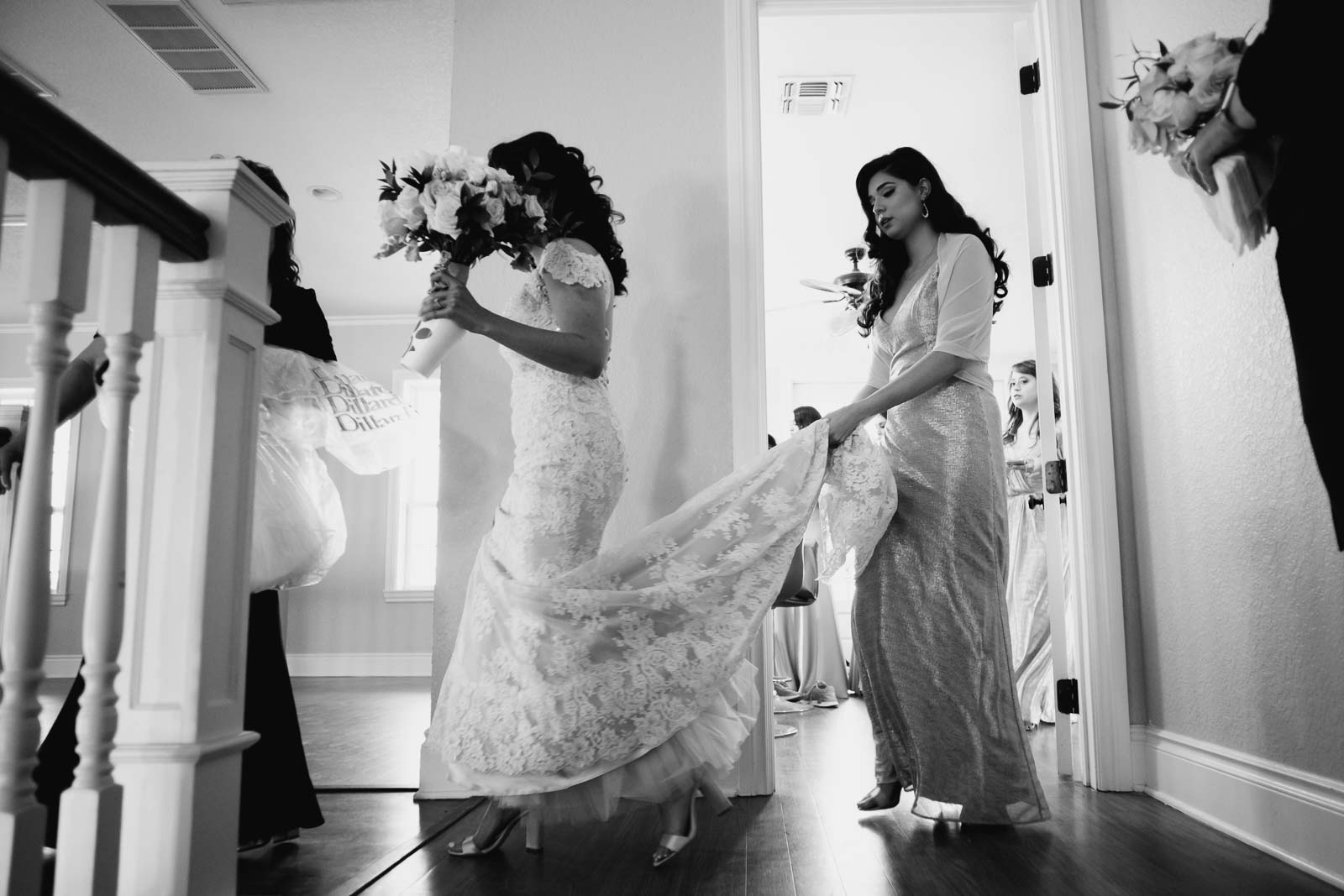 I love angle view as the bride leaves the venue to head to the church and her sister Holtz her wedding dress