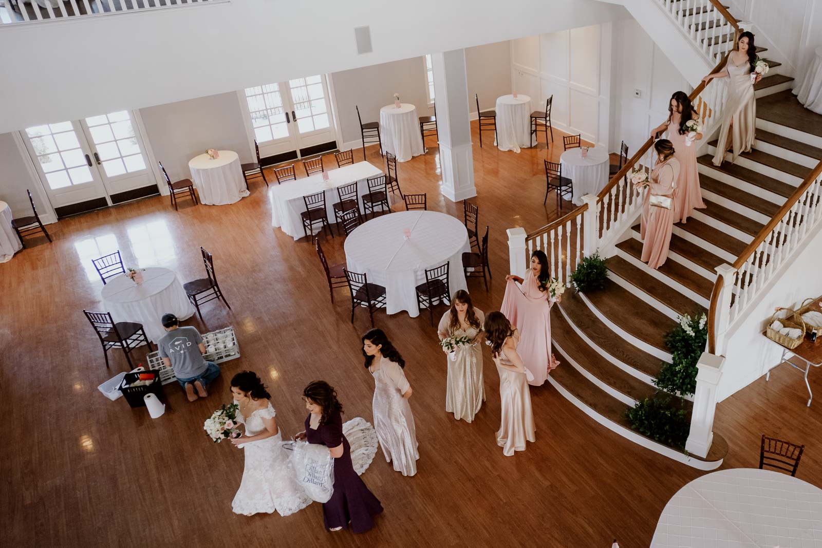 A wide angle view at Kendall point as the Bride leads the bridesmaids down the staircase