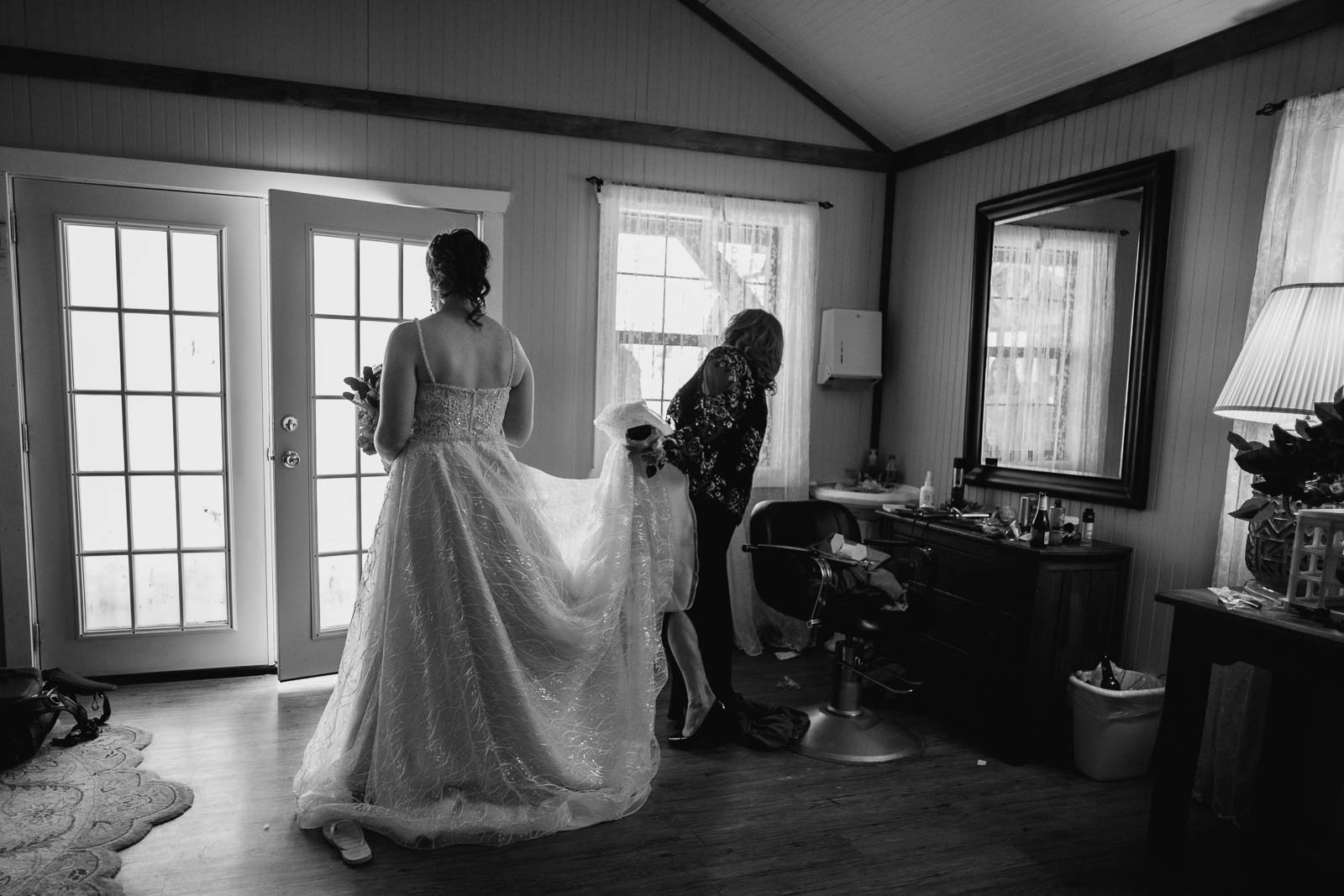 Moments before that in ceremony in the dressing room the bride stands ready to exit as her mother passed through the window
