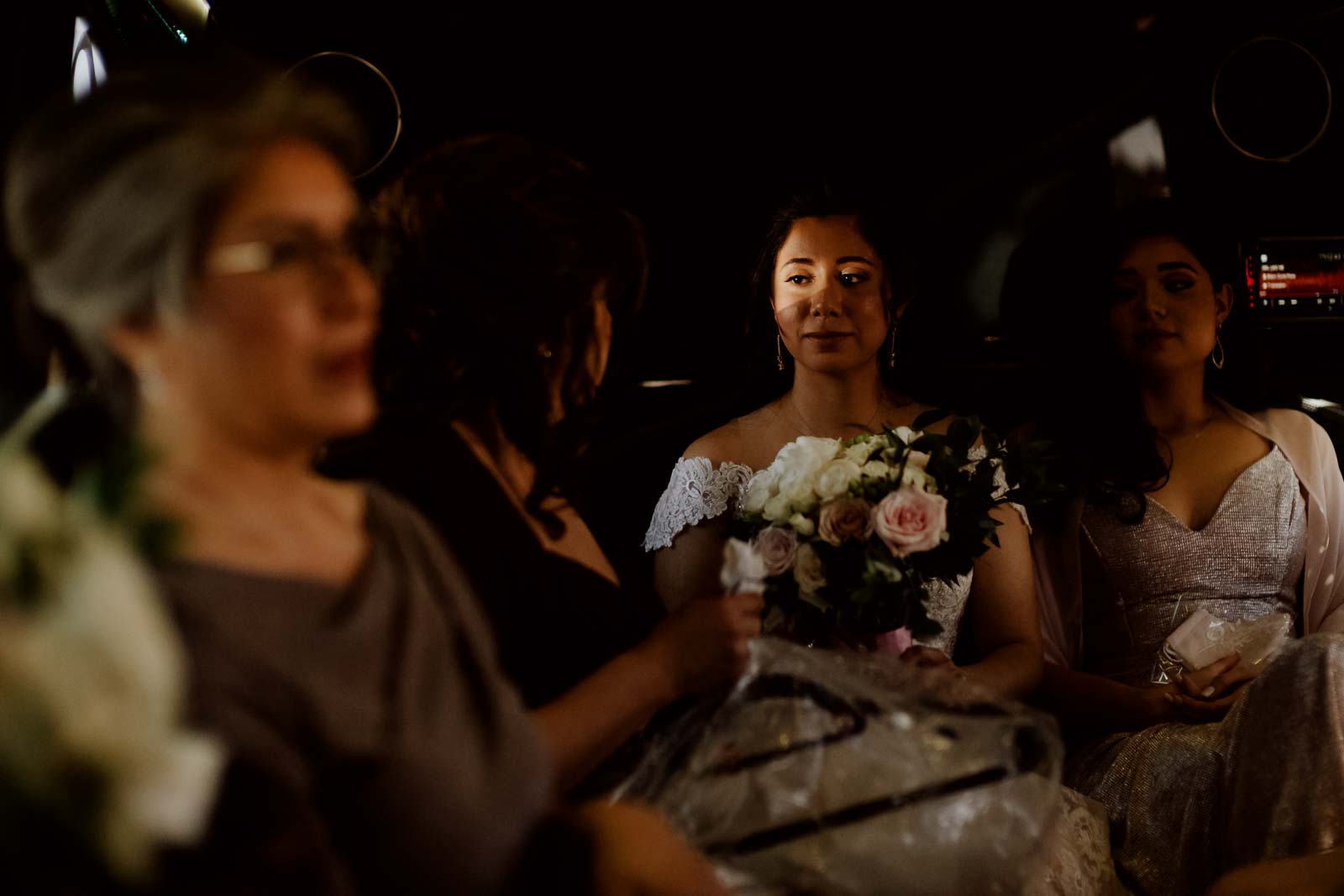Beautiful light hits the bride’s face in the limousine as they make their way to the Sacred Heart Chapel 