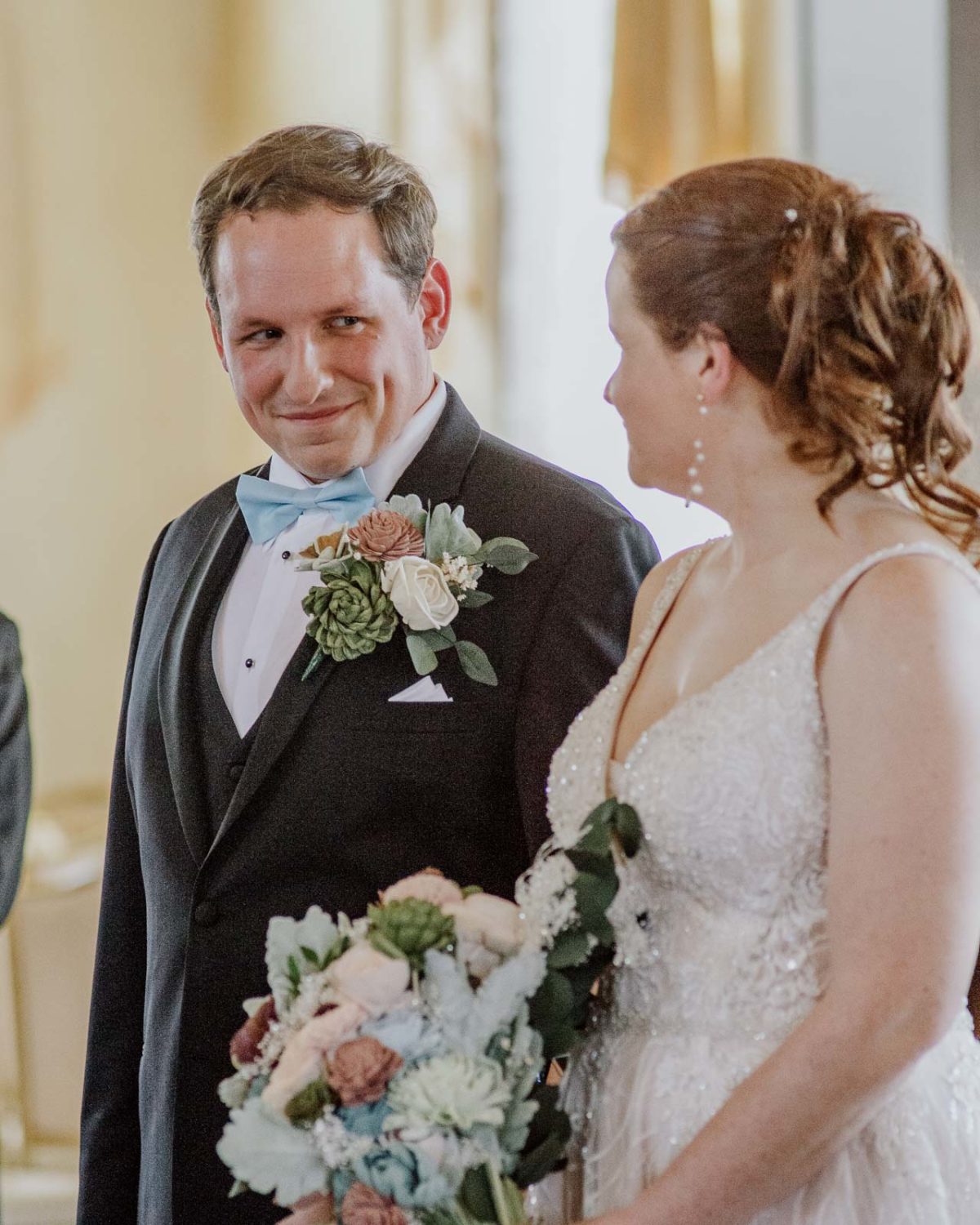  The groom looks adoringly at his bride on our wedding day during the ceremony