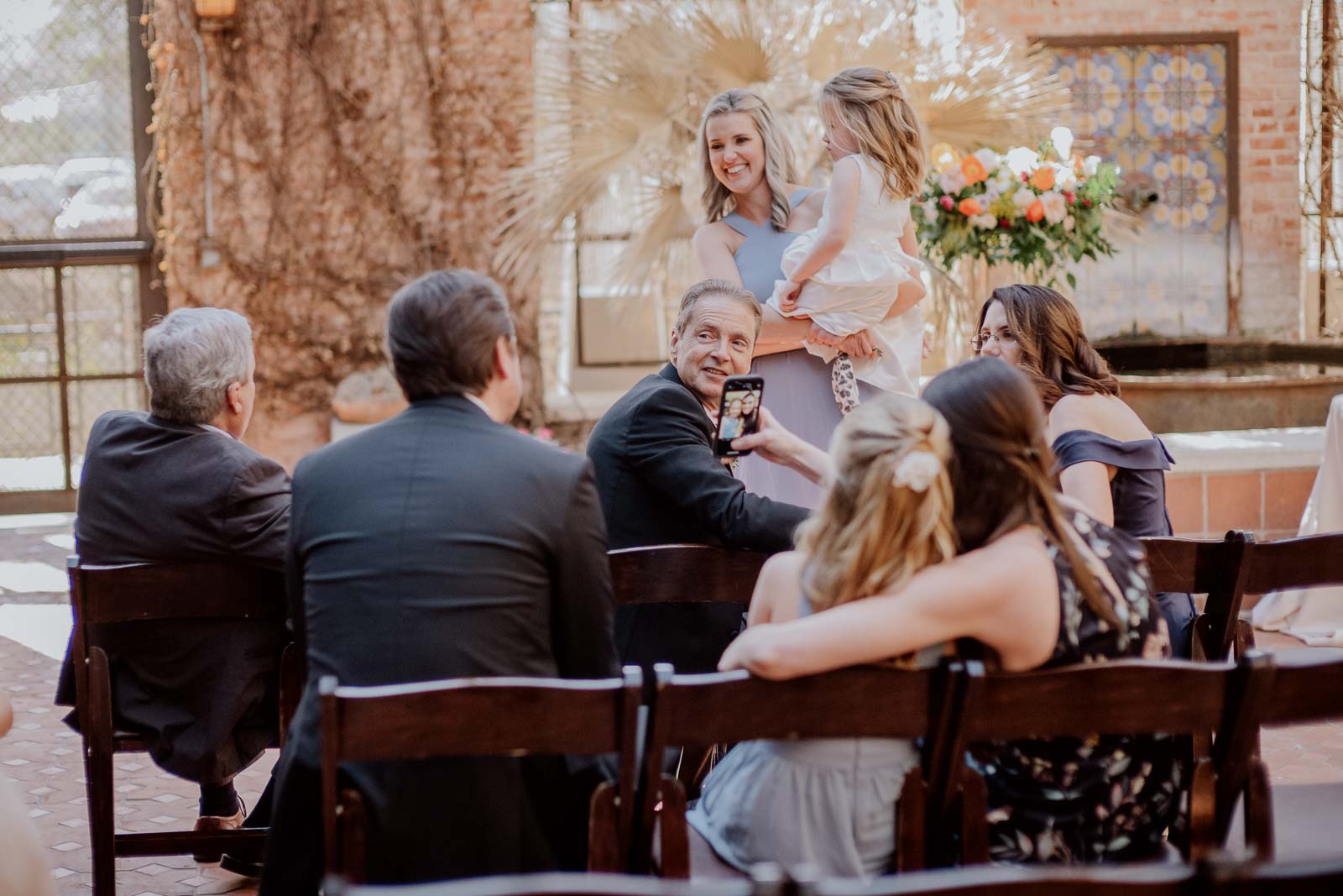 Wedding guests chat and mingle before the ceremony at Hotel Emma