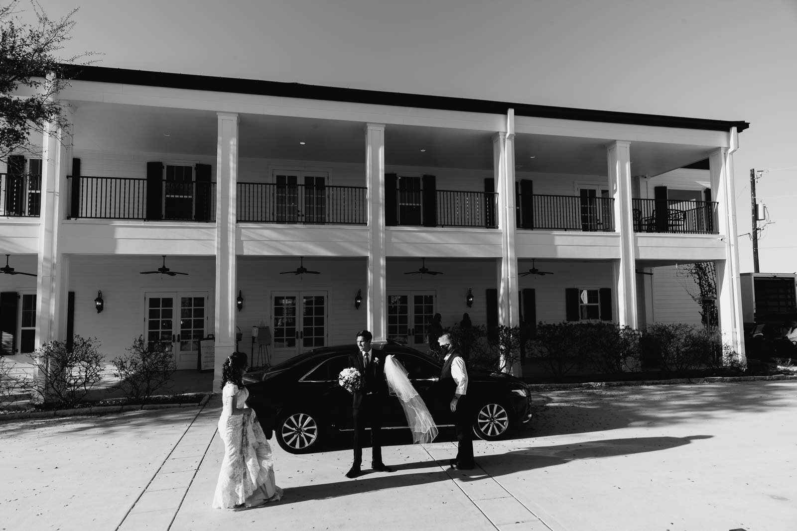 How bright and groom arrive at Kendall point as they exit the vehicle and and the groom holds the bouquet and veil