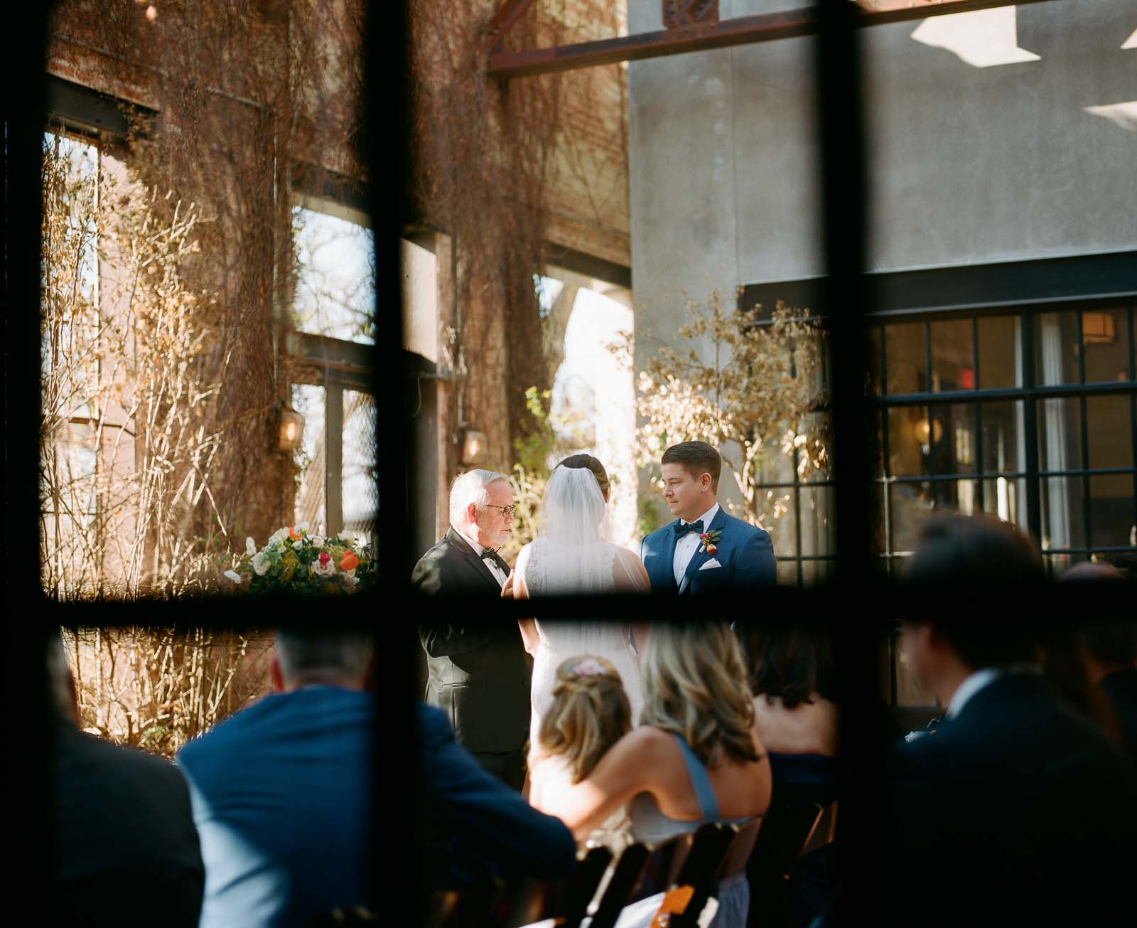 The groom looks at his bride in a loving manner at Hotel Emma for a new wedding ceremony shot for a window