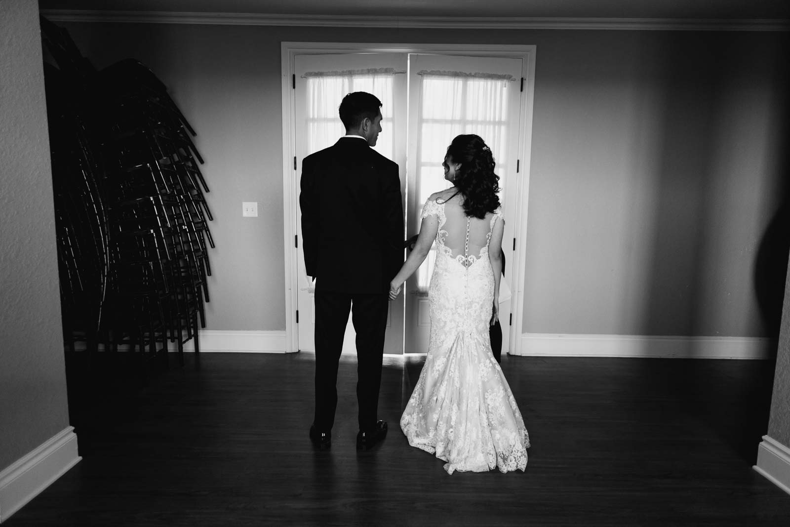 Moments before entering the reception the bride and groom are held up in a room private room