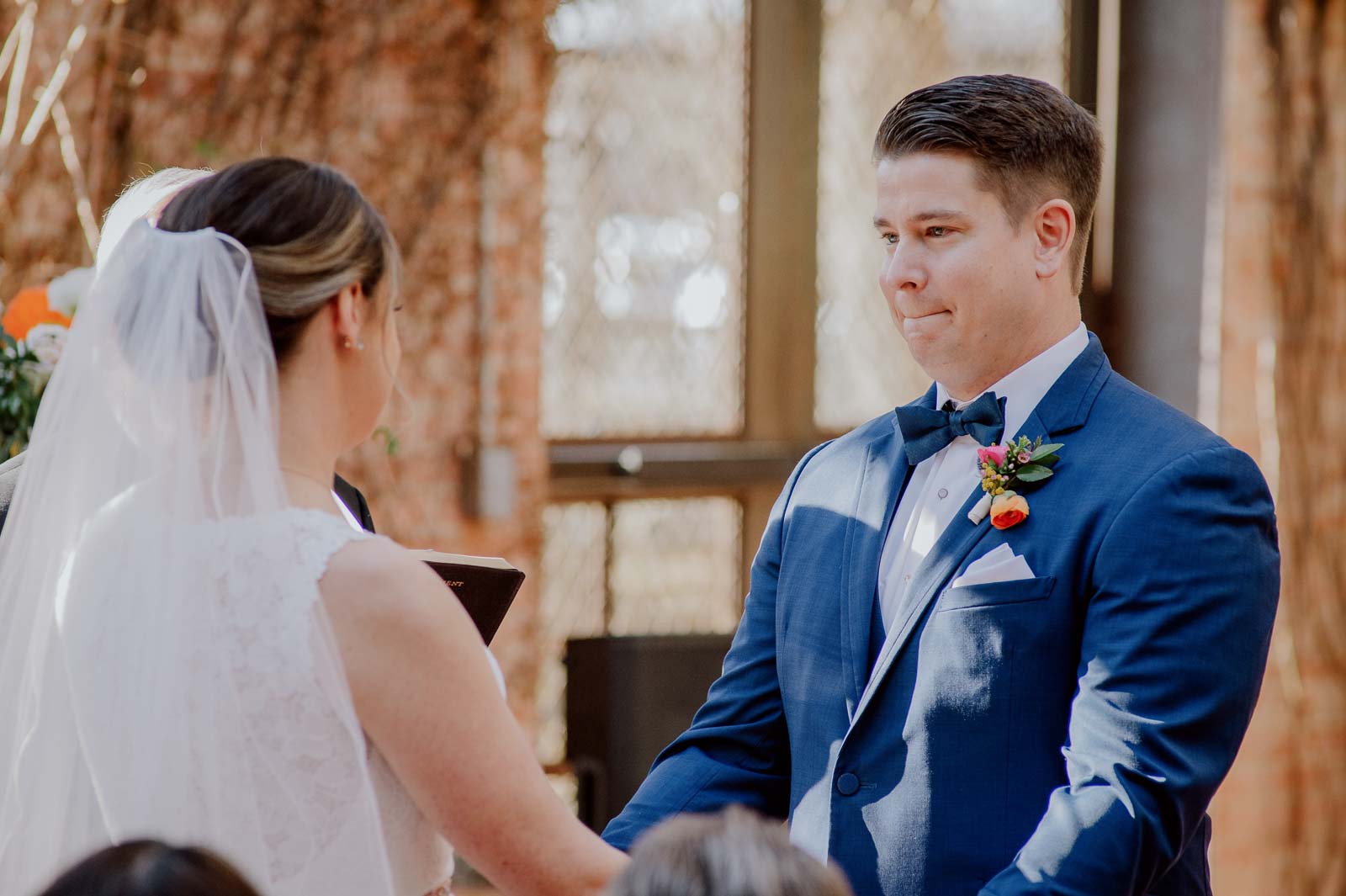 As a couple recite the vowels the groom gets emotional as he looks at his bride