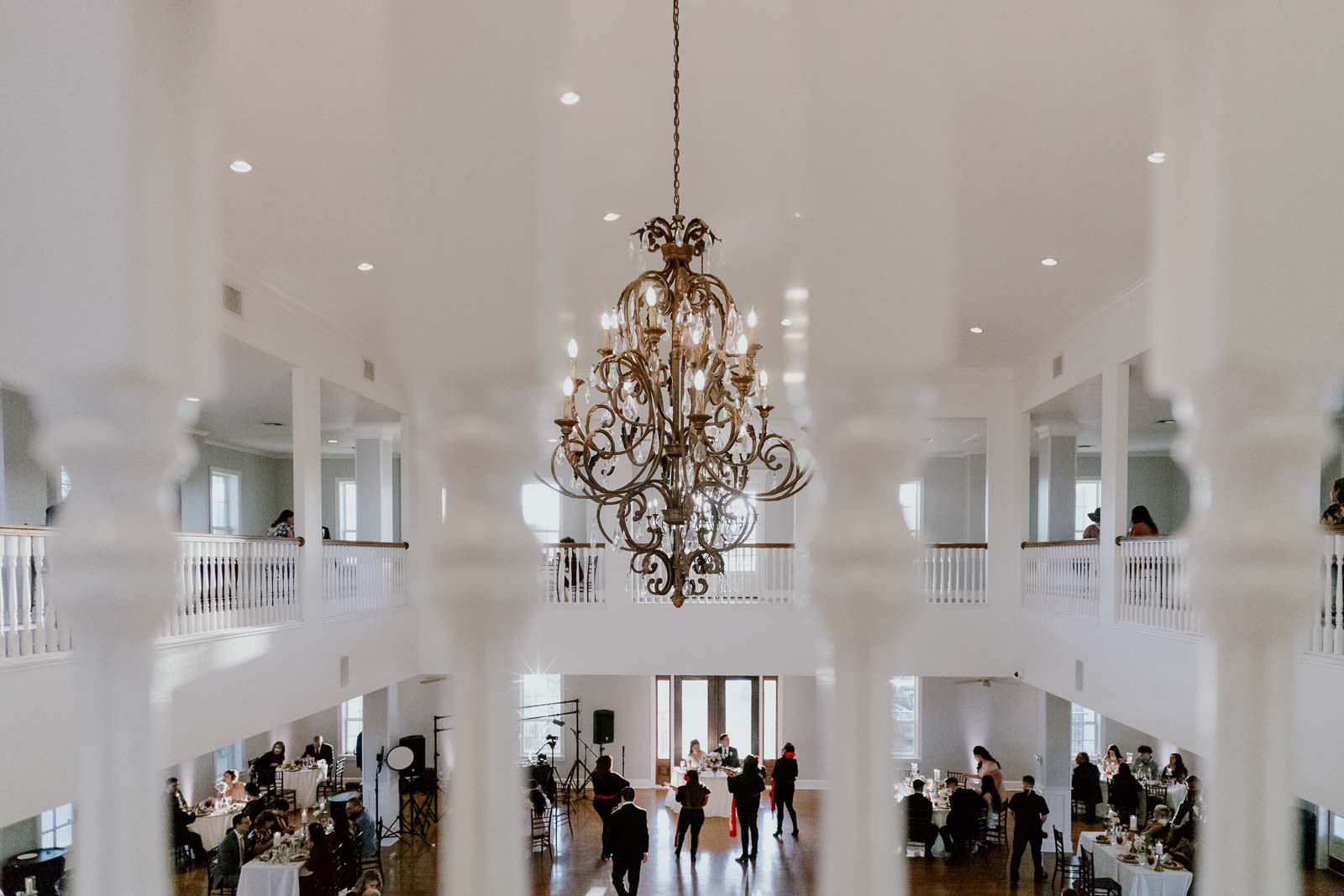 A wide angle view shows the Marriott she’s playing to the bride and groom with a chandelier in the foreground