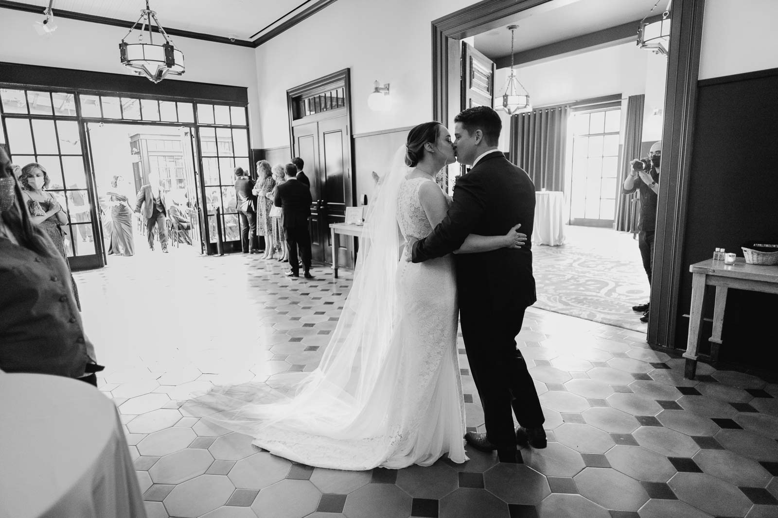 Philip Thomas photographs The bride and groom in a candid moment as a couple kiss unaware of the camera