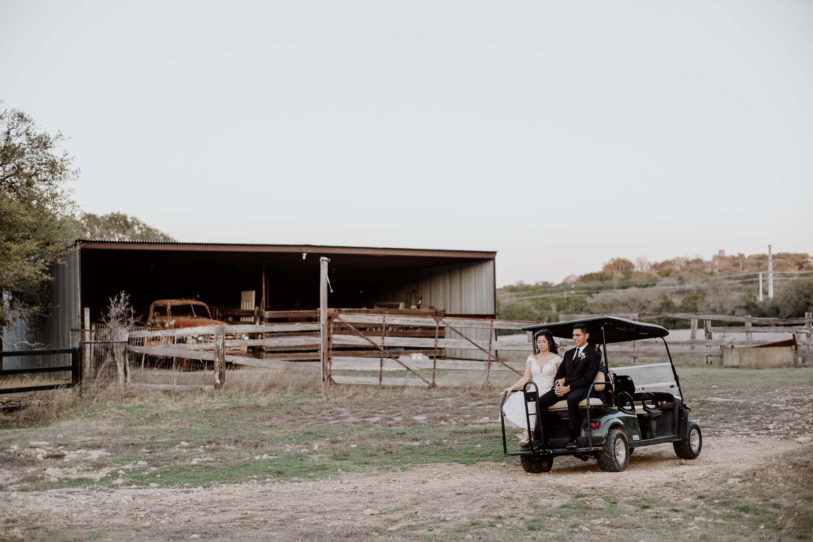 The couple I picked up in a golf cart and make their way back towards the wedding reception at Kendall point with antique cars in the ground