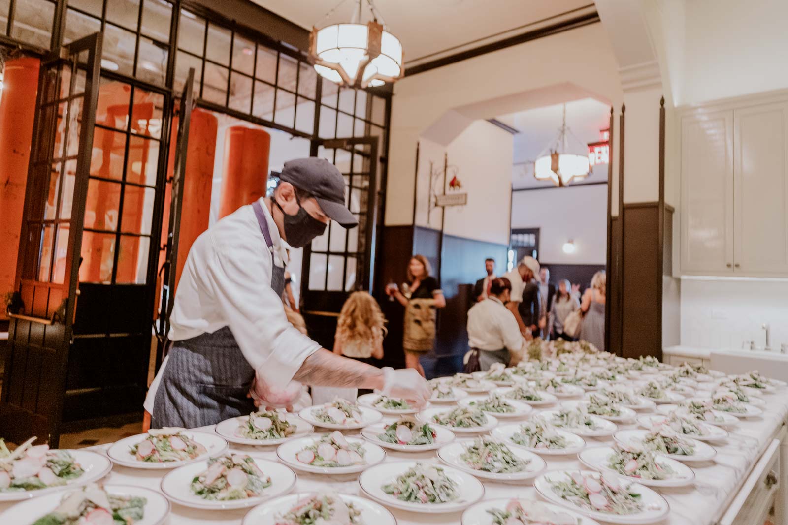 A chef prepares salads for the wedding reception outside the elephant room at Hotel Emma