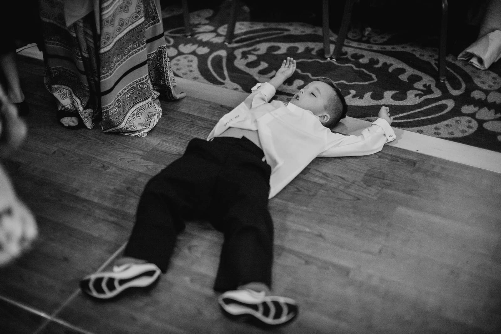 The ring bearer Saenz asleep during the wedding reception floor