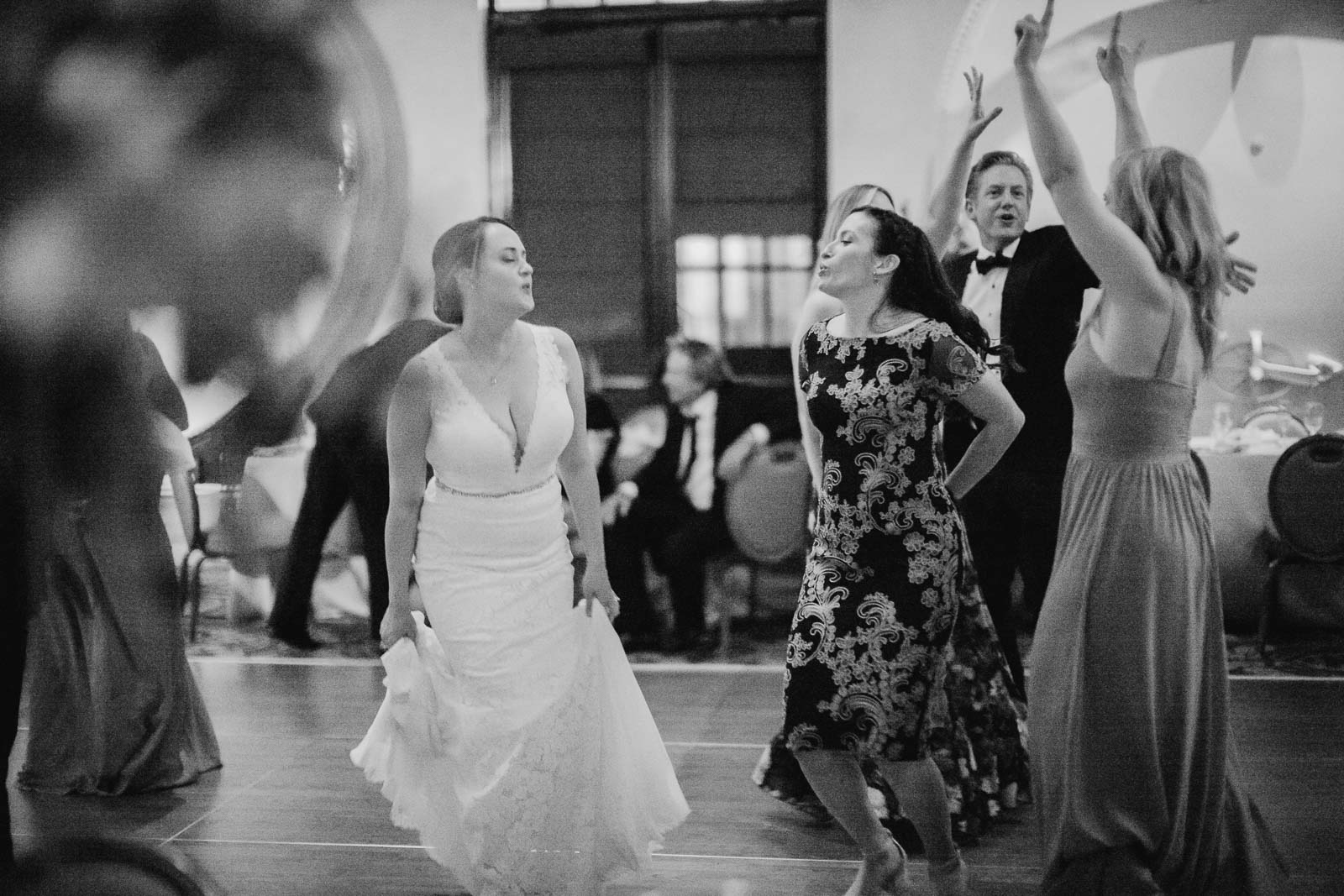 The bride dances with another guest during the wedding reception