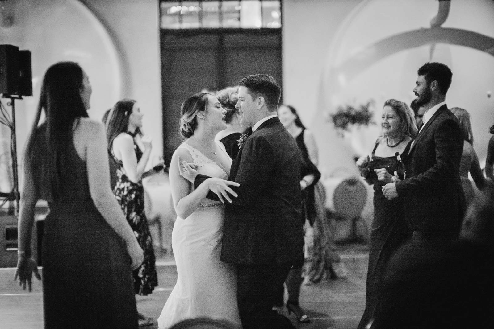 As guests dance around during the wedding reception at Hotel Emma the bride and groom dance together