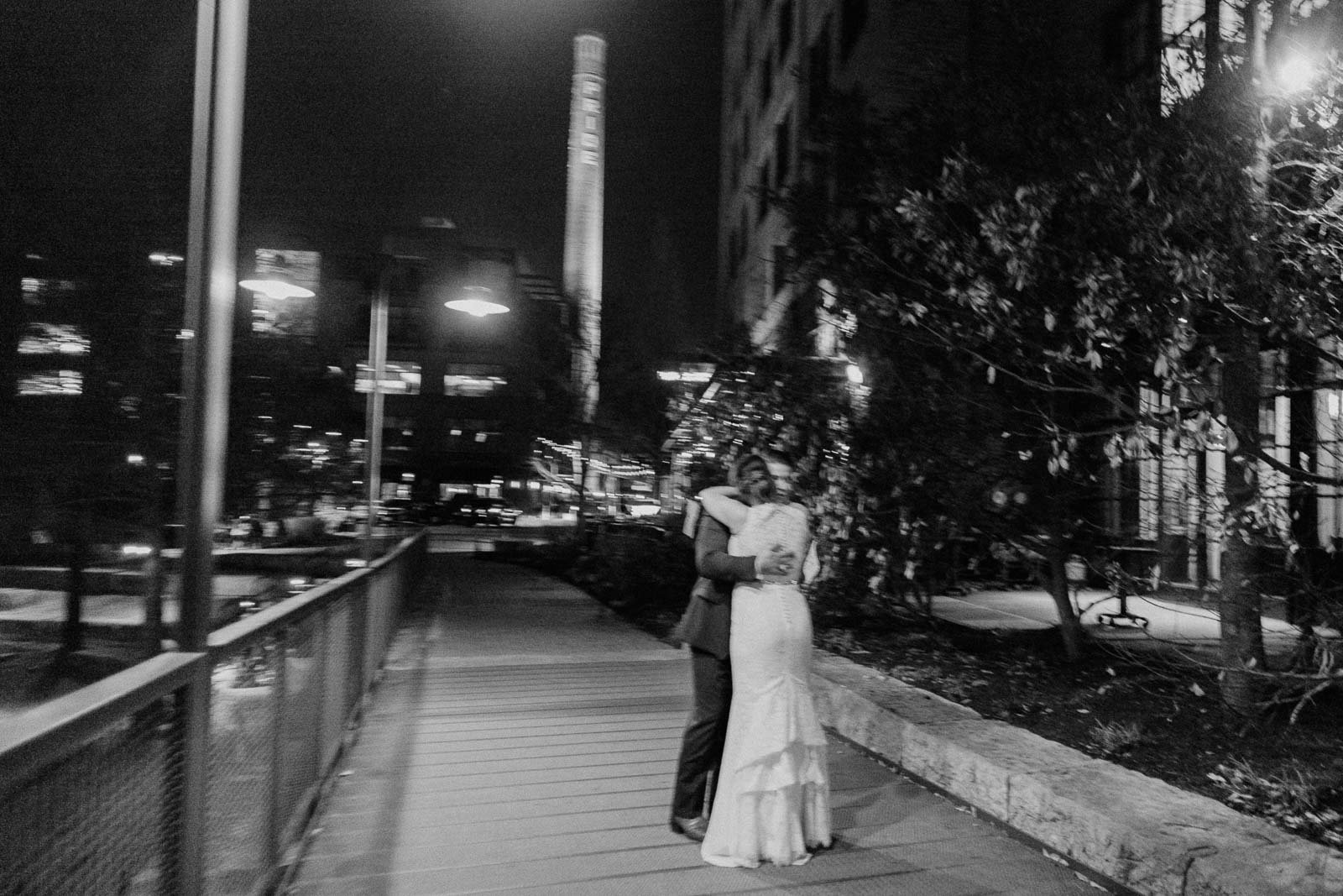 With some intended camera movement the bride and groom have a hug as the night comes to an end at the wedding reception but their lives have just started together