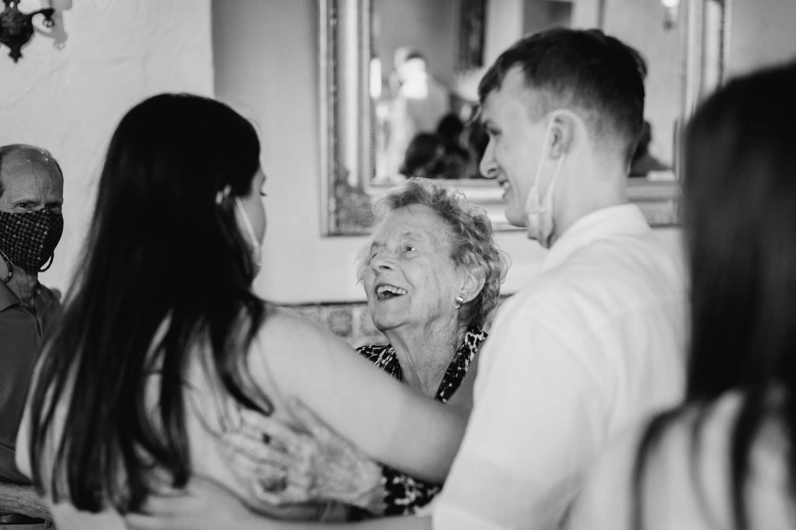 The grandmother the patriarch of the family looks adoringly at Avery the bride to be during the rehearsal dinner at la Fonda