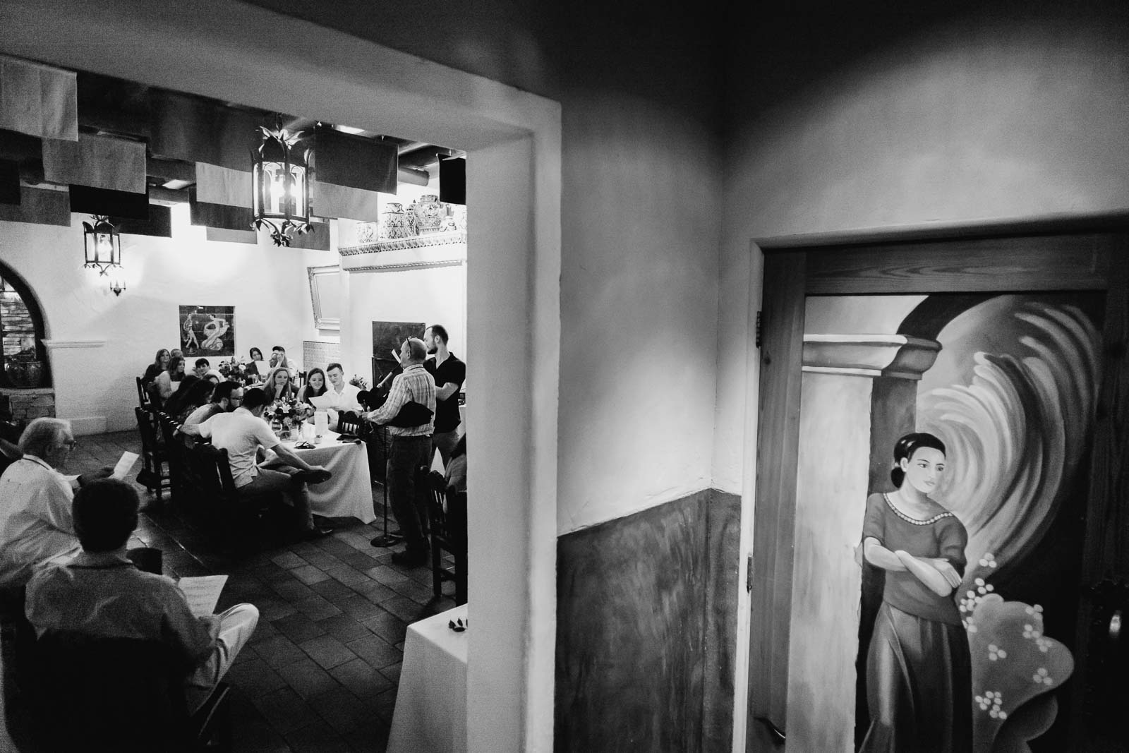 I photograph of a mirror painted on a restroom door at la Fonda during the rehearsal dinner and a bag pipe is played by the uncle