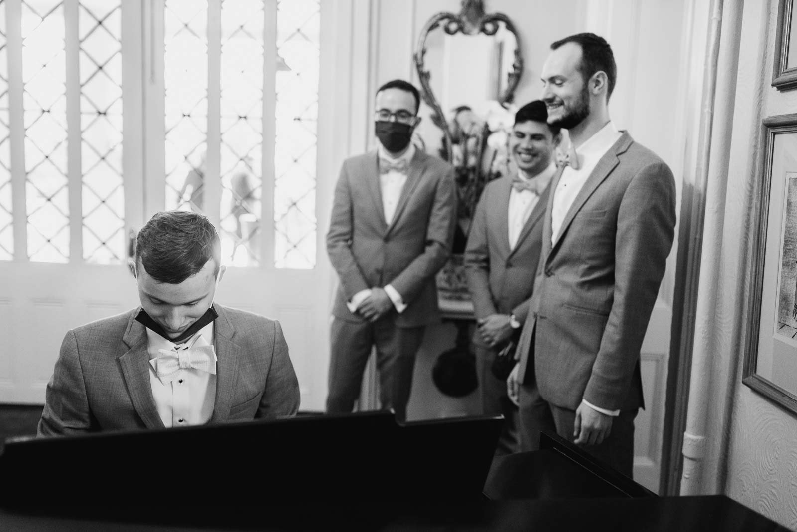 The groom plays on the Steinway piano at The Argyle as the groomsmen stand behind him :-)