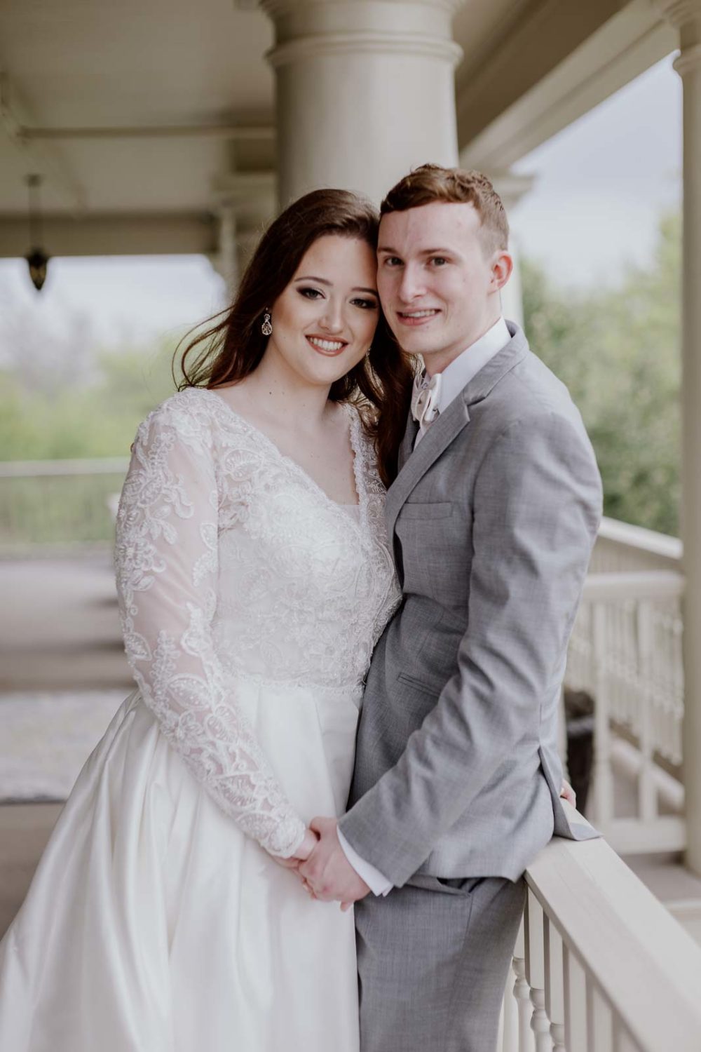 A post photo of the bride and groom holding hands