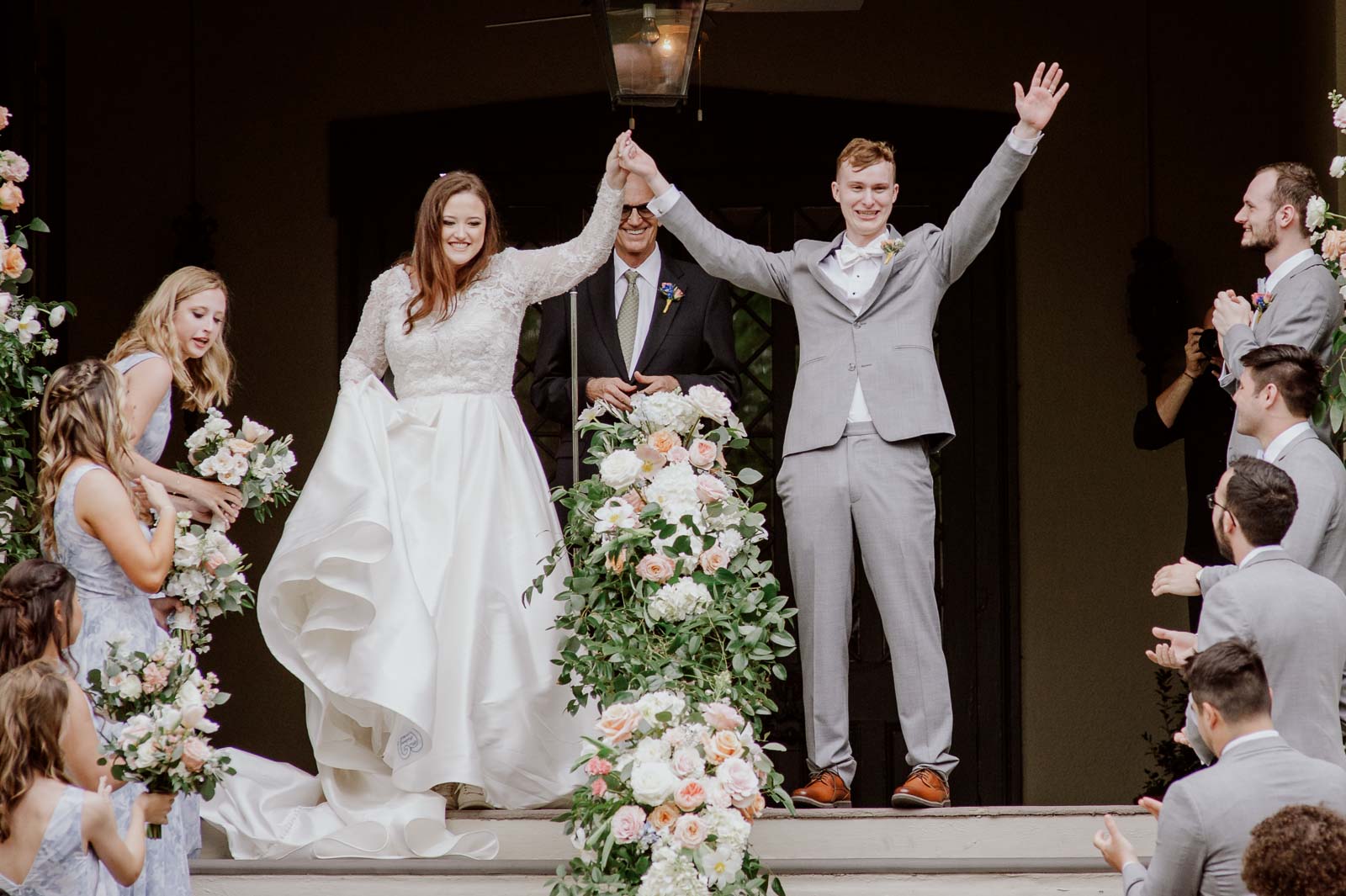 A close up as the bride and groom raise hands