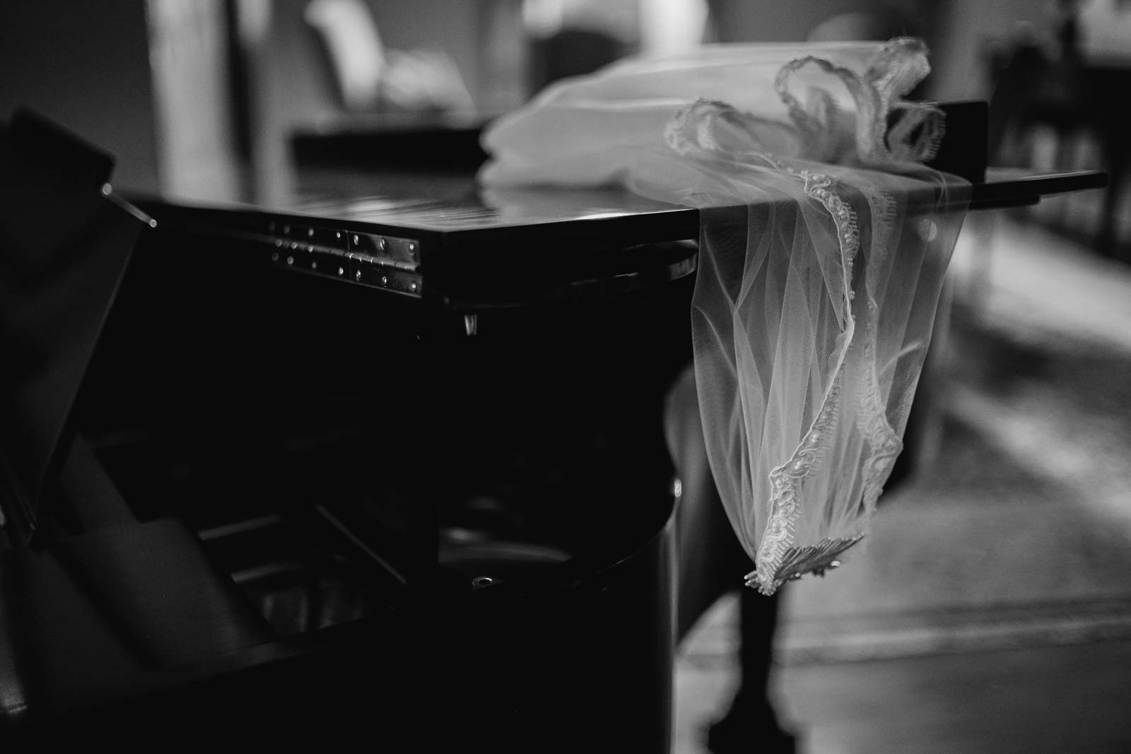 A gorgeous photo of a veil hang on off the Steinway piano black-and-white shot on a Leica rangefinder