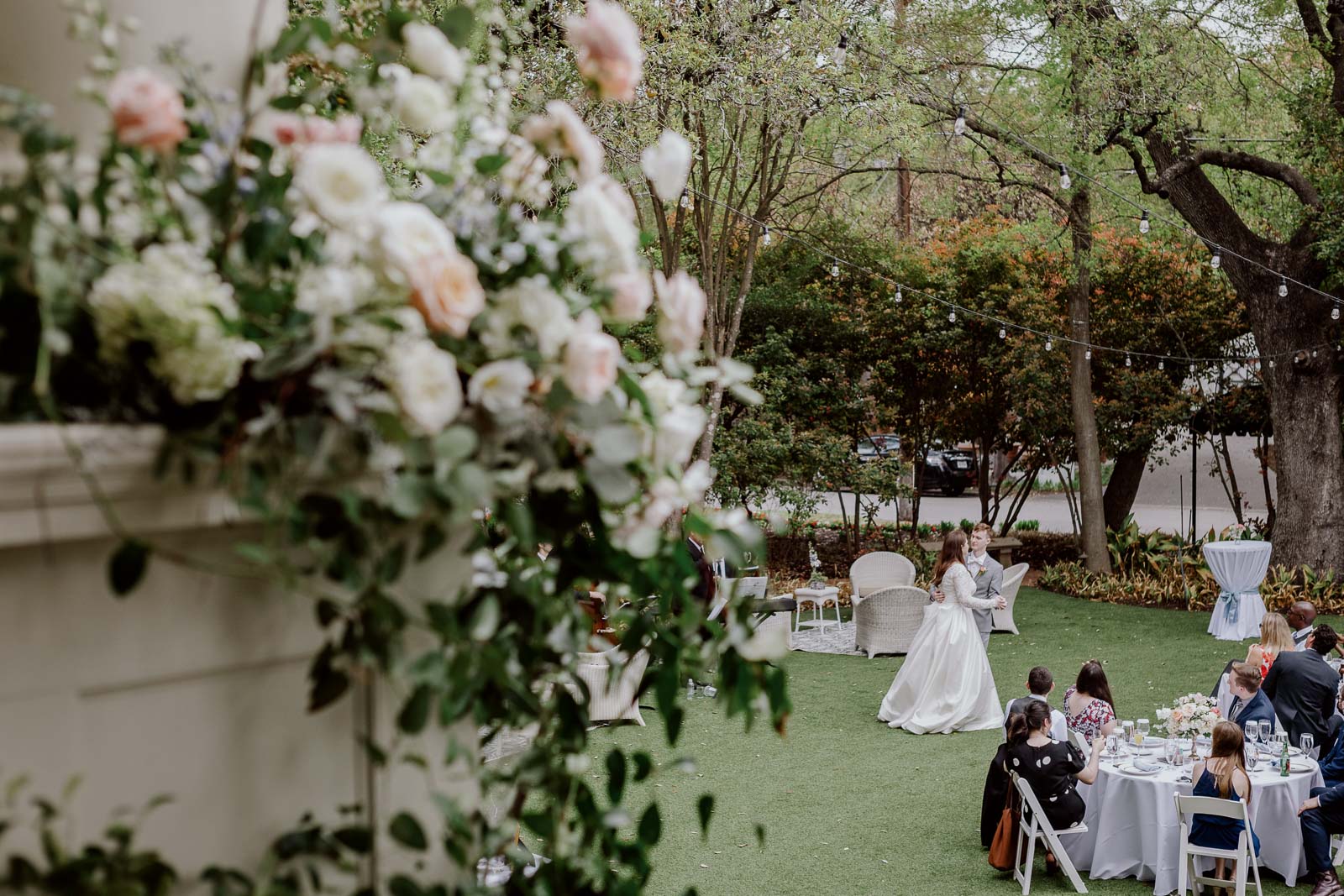 First dance as a bottom groom circles by slowly on the lawn of The Argyle in the foreground of the beautiful flowers that cutting the staircase