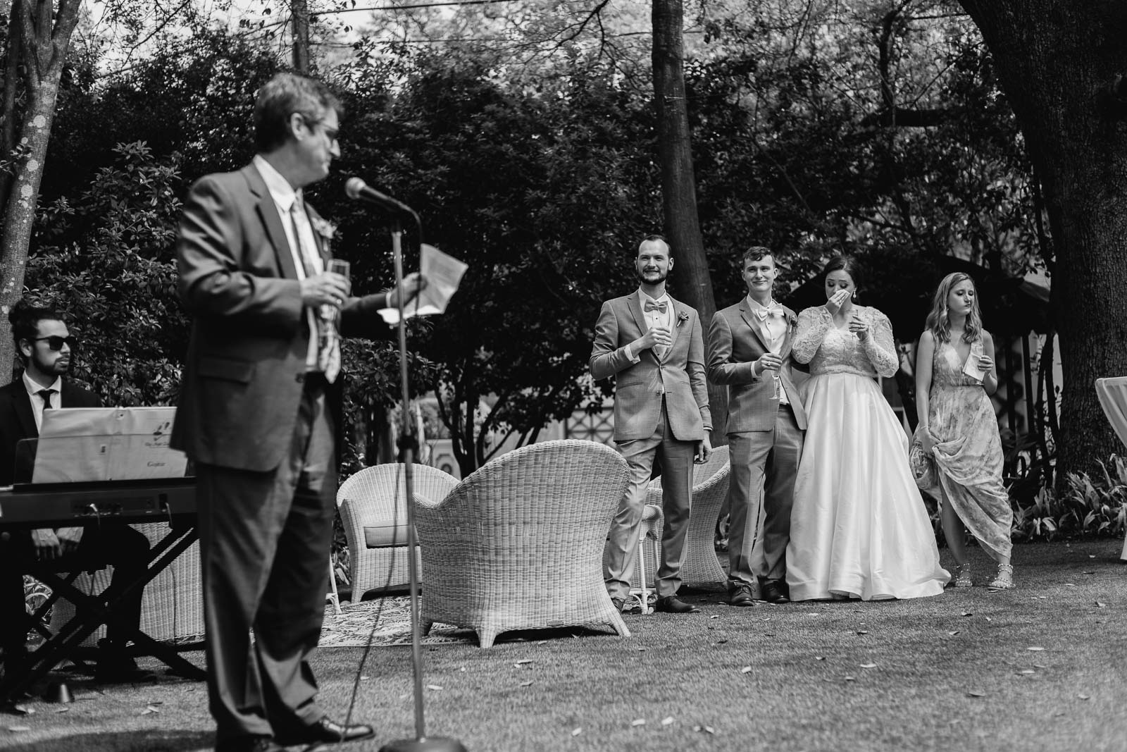 During the first host the bride and groom wipe tears as the father of the bride