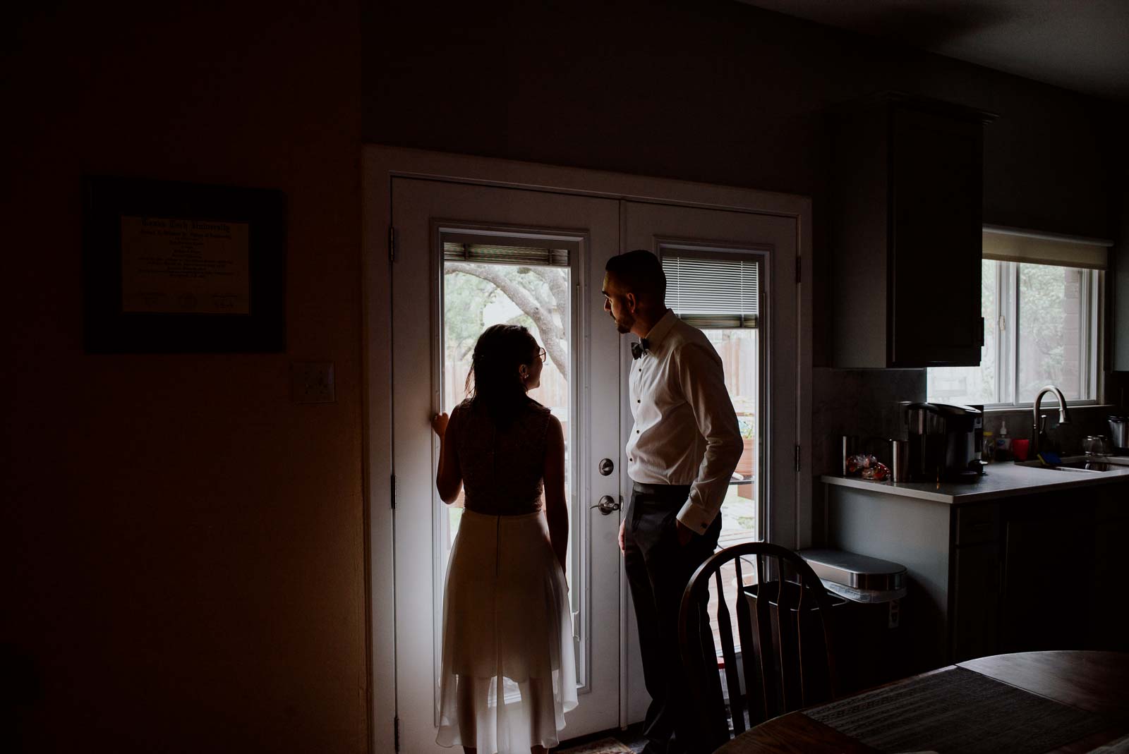 Groom stands by window Sacred Heart Chapel-Leica photographer-Philip Thomas Photography