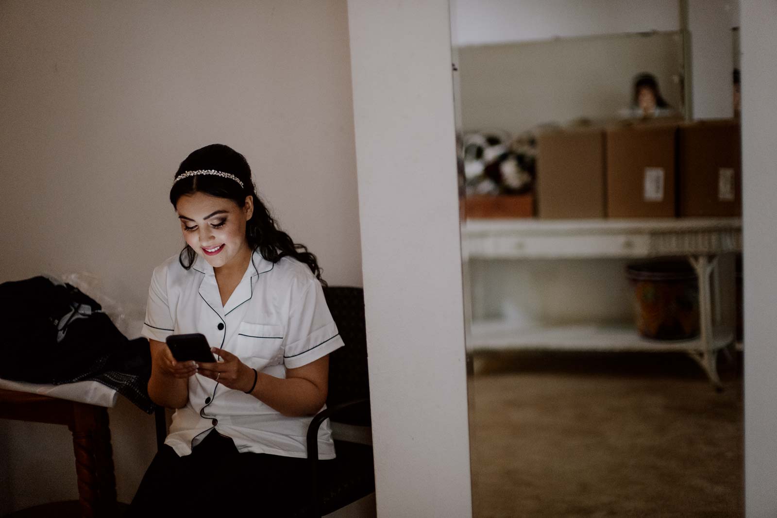 Bride checks her iphone at Sacred Heart Chapel-Leica photographer-Philip Thomas Photography