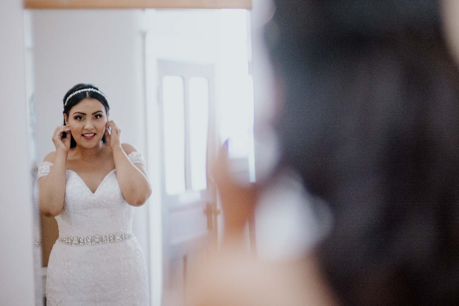 Arsy the bride checks her earrings look perfect in mirror  Sacred Heart Chapel-Leica photographer-Philip Thomas Photography