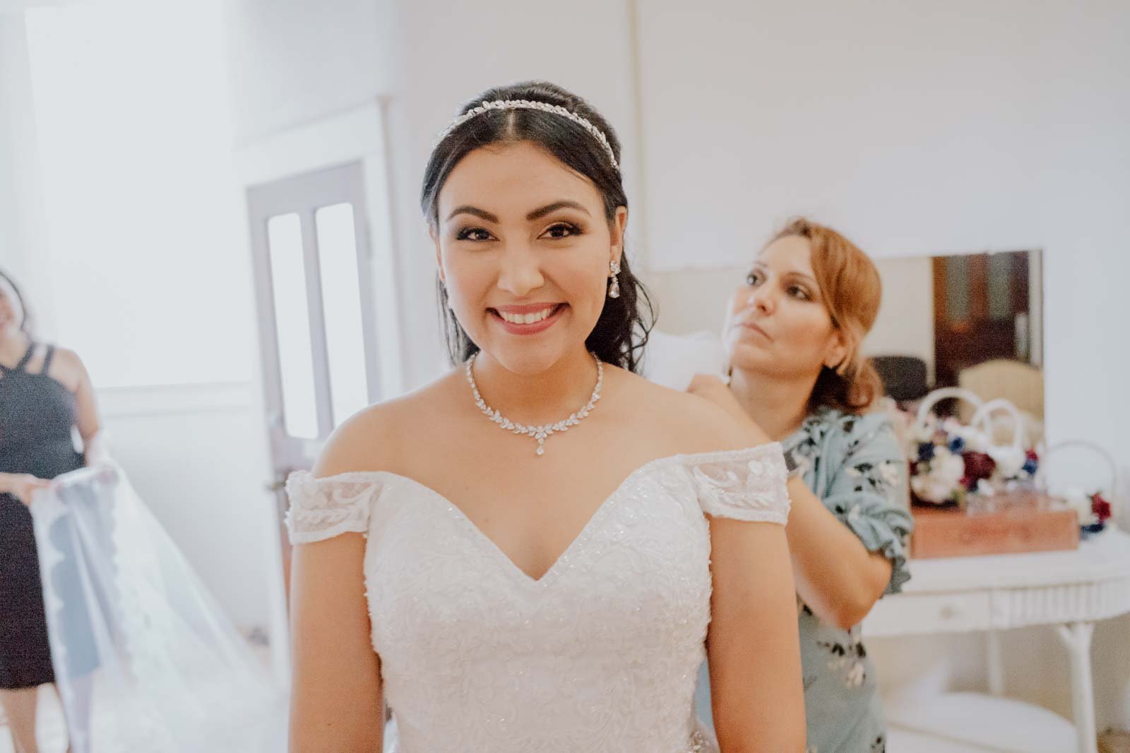The bride beams with a wide smile at mirrorPhilip Thomas Photography