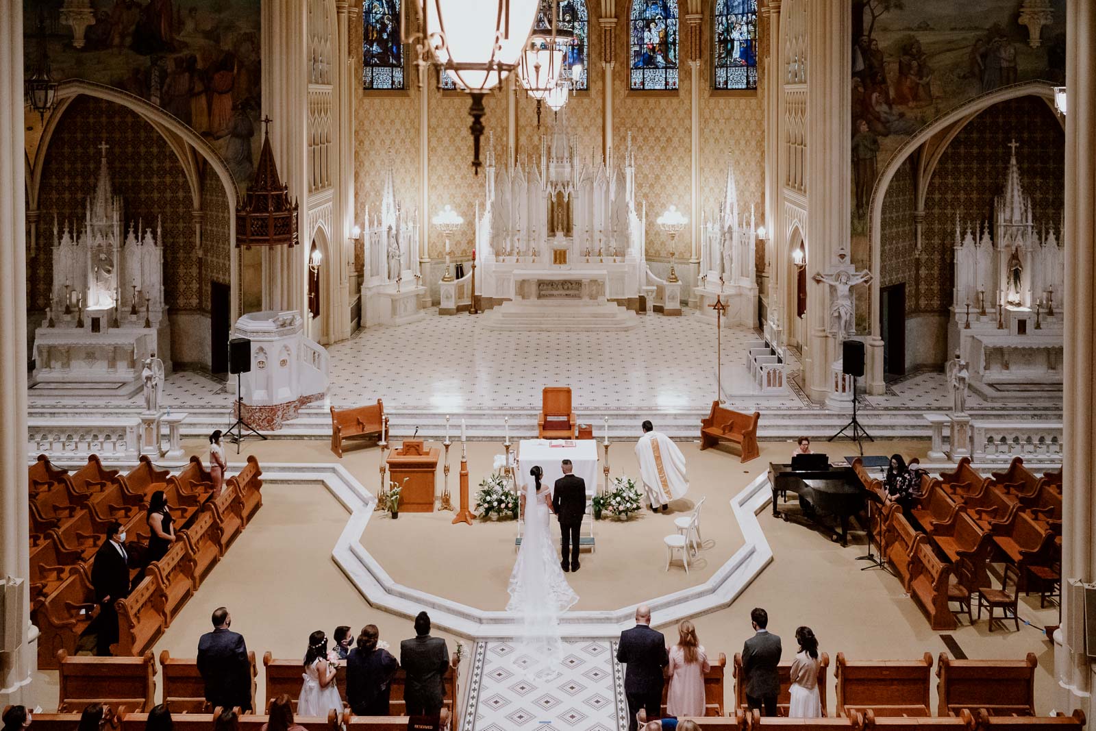 A wide angle shot from the upper balcony of a wedding ceremony at  Sacred Heart Chapel-Leica photographer-Philip Thomas Photography