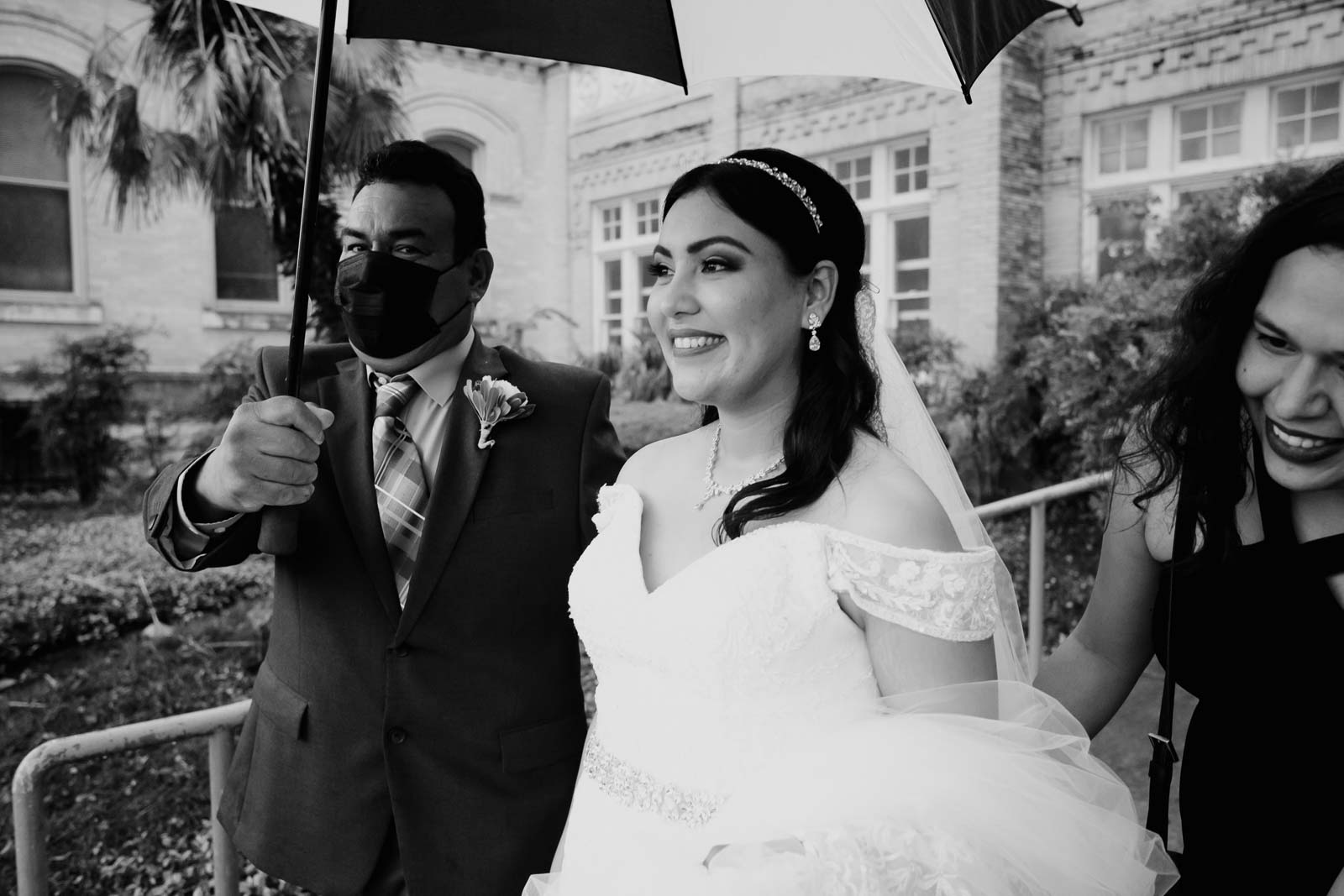 The bride leave as a shower of rain on a Spring Texan day at  Sacred Heart Chapel-Leica photographer-Philip Thomas Photography