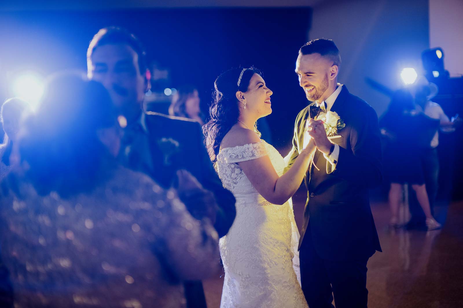 A couple backlit near stage on wedding day Sacred Heart Chapel-Leica photographer-Philip Thomas Photography