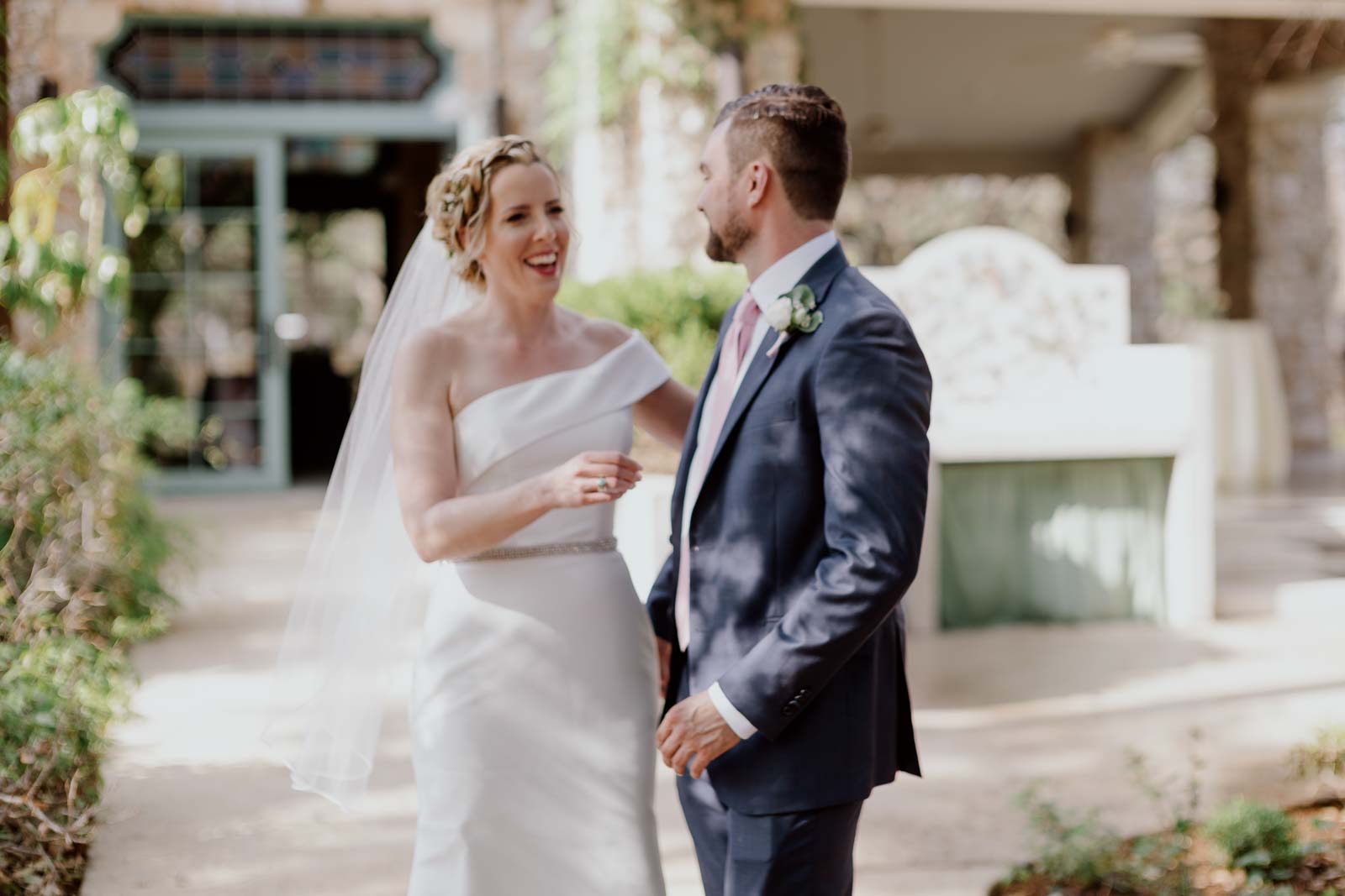 The couples first look at the veranda as the groom turns to see his pride for the first time