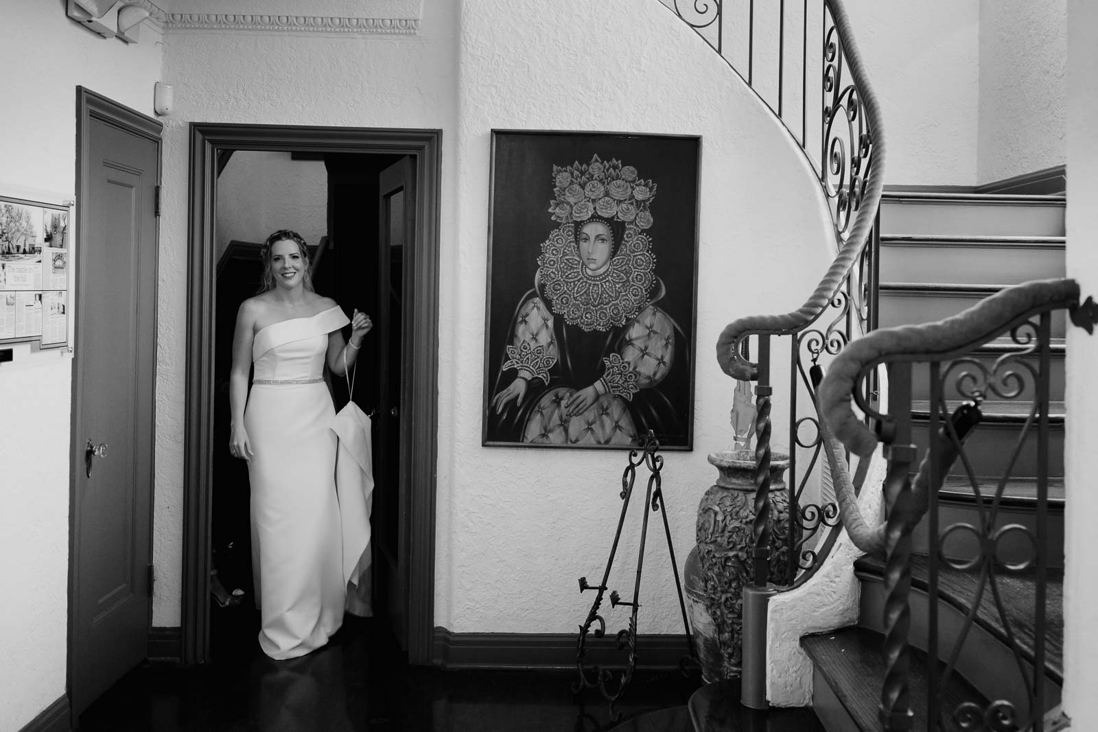 The bride exits the bridal room with a ornate staircase at the veranda San Antonio