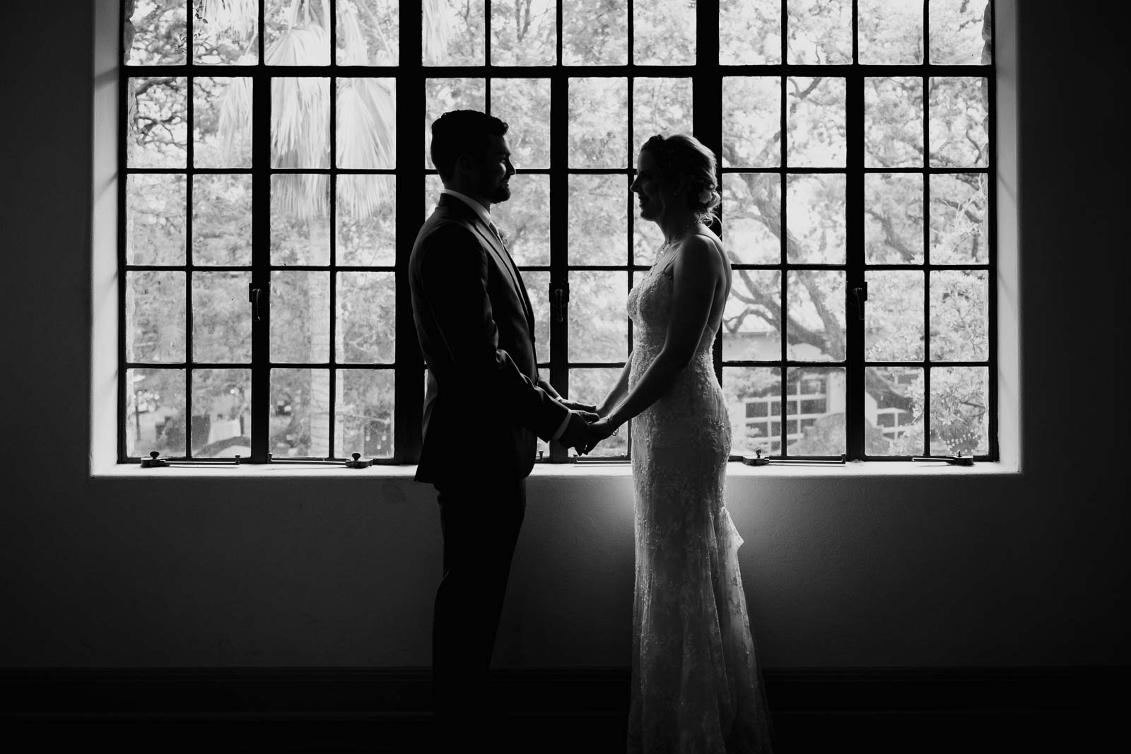 A post photo at the veranda on the upper level in the conference room with a big beautiful glass windows and a couple standing in front of it