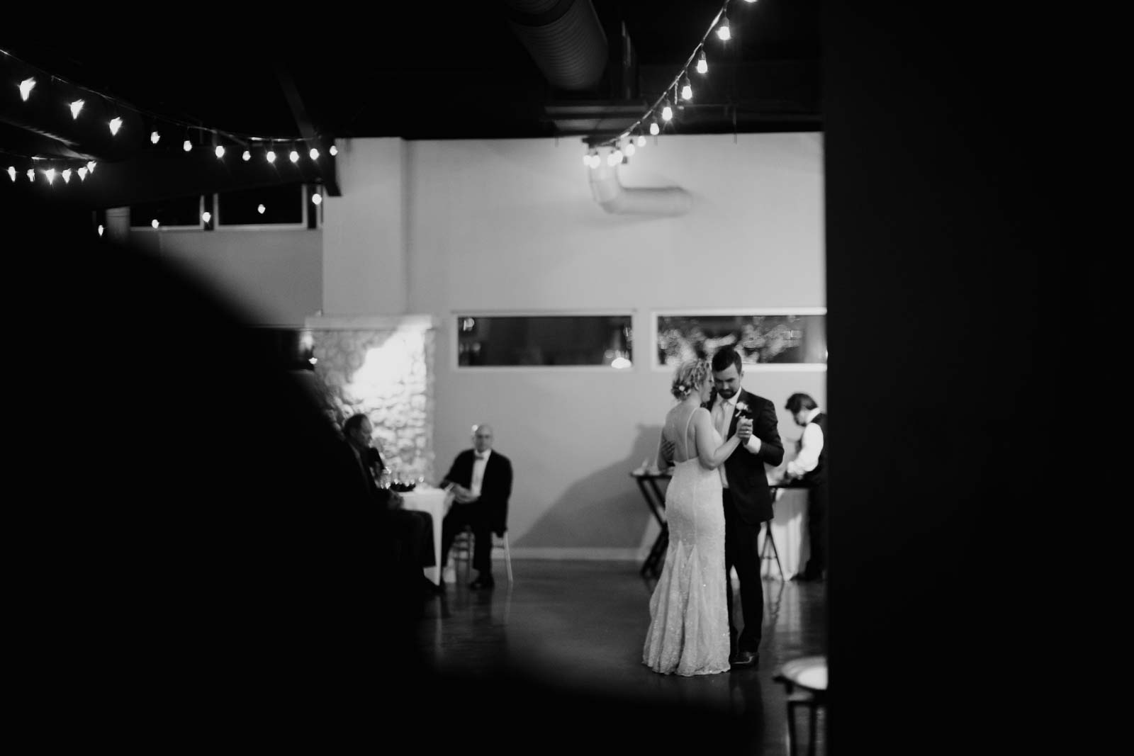 Couples first dance multi layered with the Beautiful lighting above them and a couple dancing very close