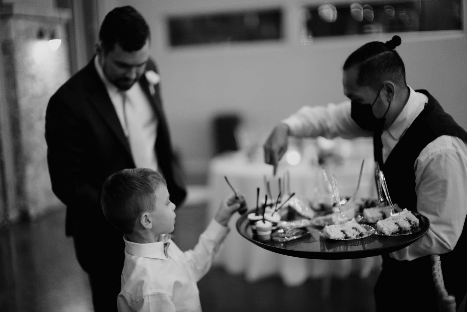 The groom San picks out his favorite dessert as a server hands out cake