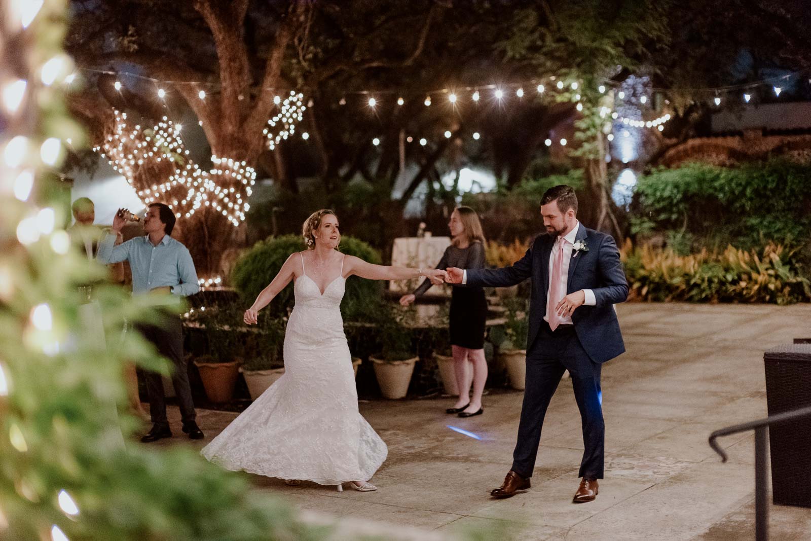 A couple dance and spin the bride on the outdoor wedding reception at the veranda