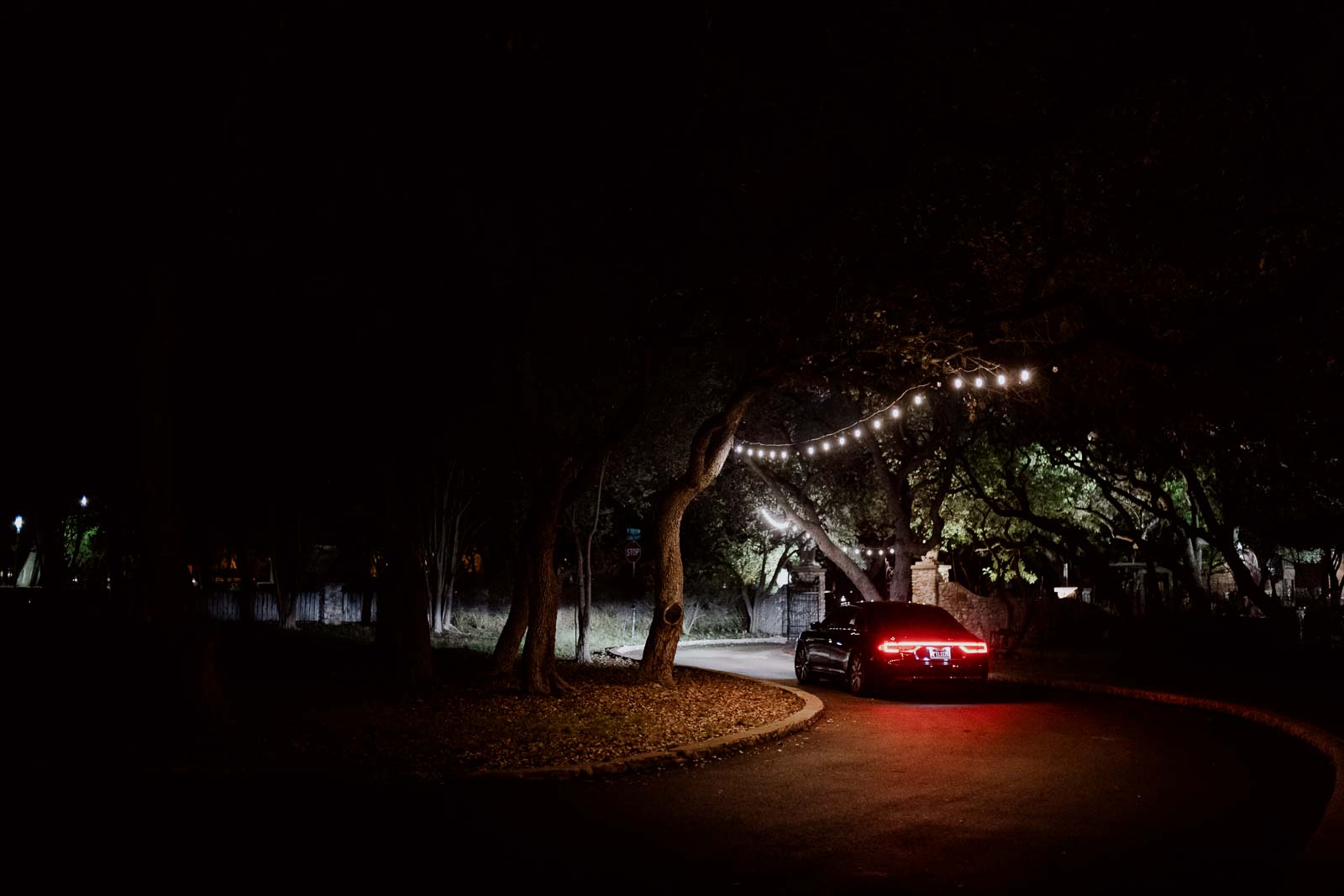 A limo carries the bride and groom as a part of a random with tea lights in the sky