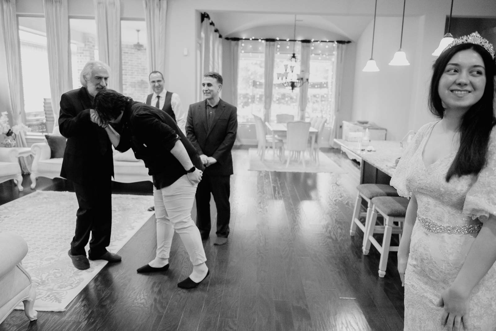 The groom kisses the hand of the brides father in the welcome ceremony