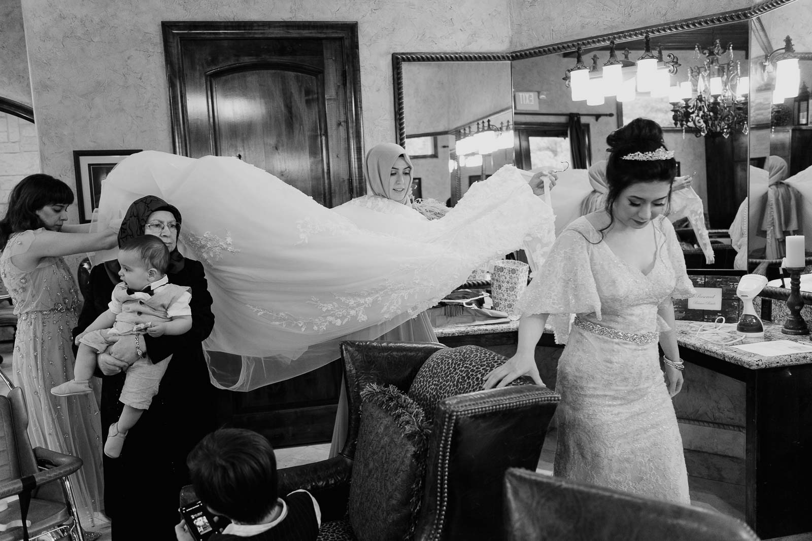 Bride’s veil is taken across the room