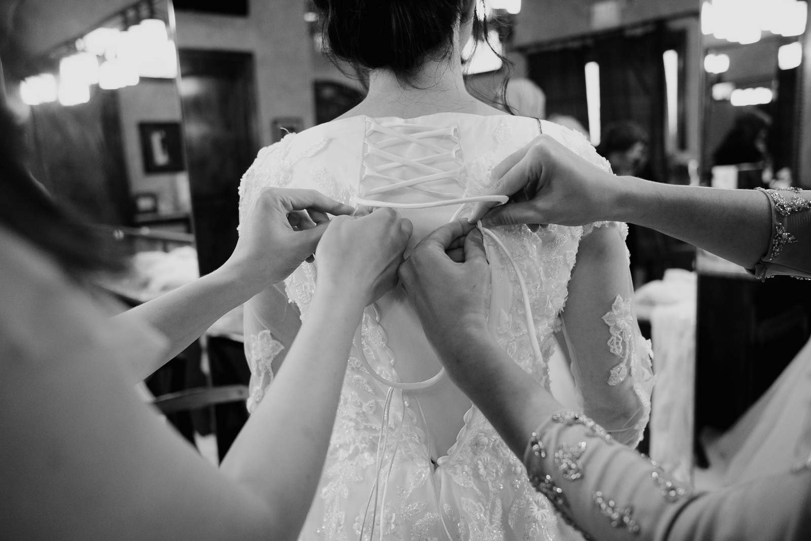 Hands at the back of the dress as the dress is tied