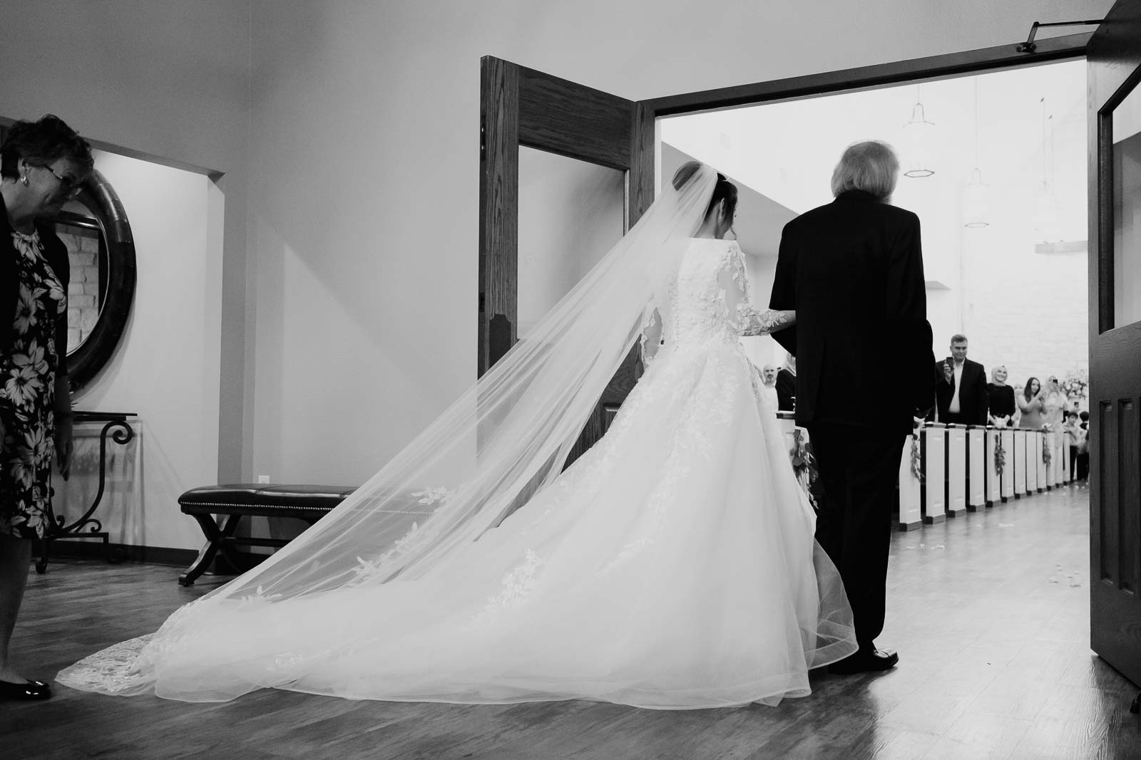 Bride and father enter the doors of the ceremony as brides and father enters the doors 