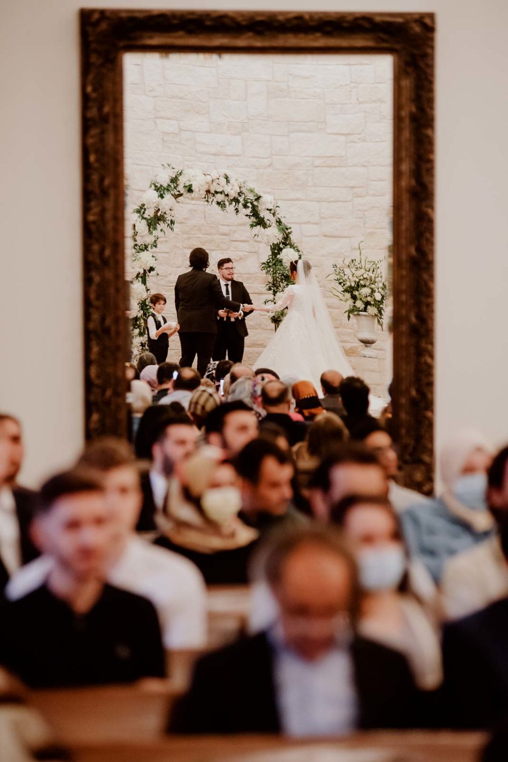 A unique perspective of the ceremony in the long lens photograph reflection of the mirror in the back of the room new