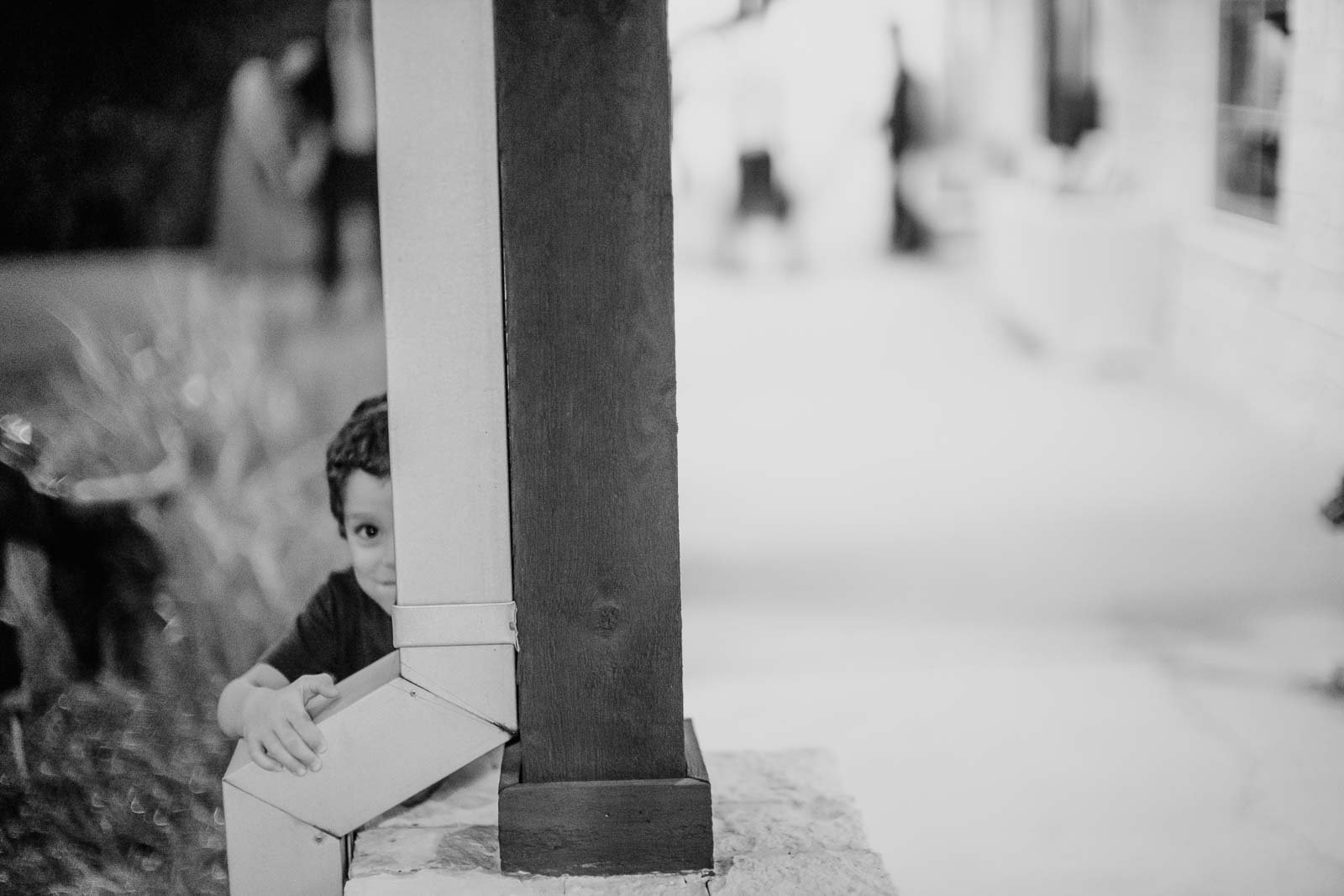 A little boy peeks at the camera from a pillar Briscoe Manor