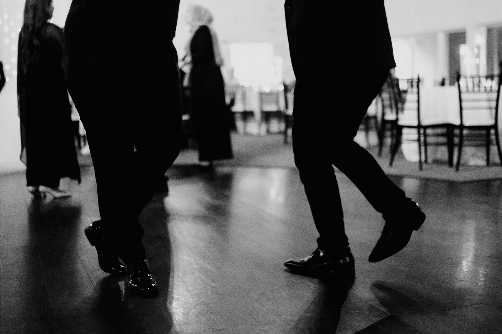 Guests dance silhouetted against floor