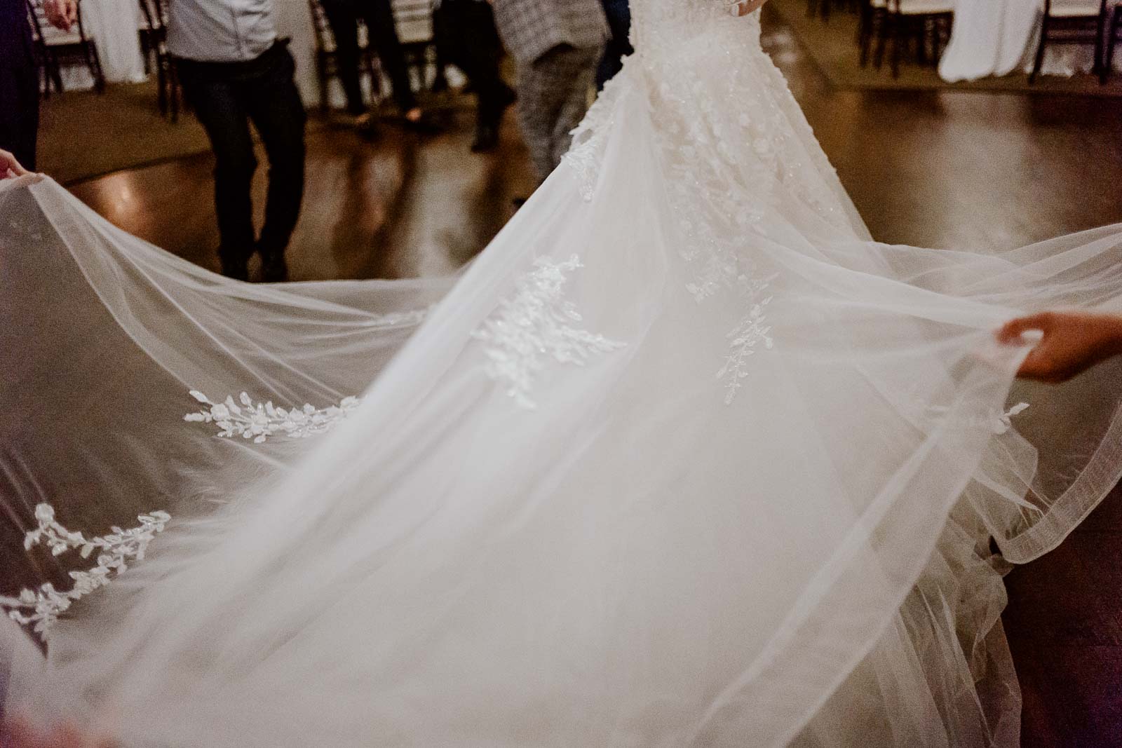 The brides dress is pulled in different directions at a reception Turkish