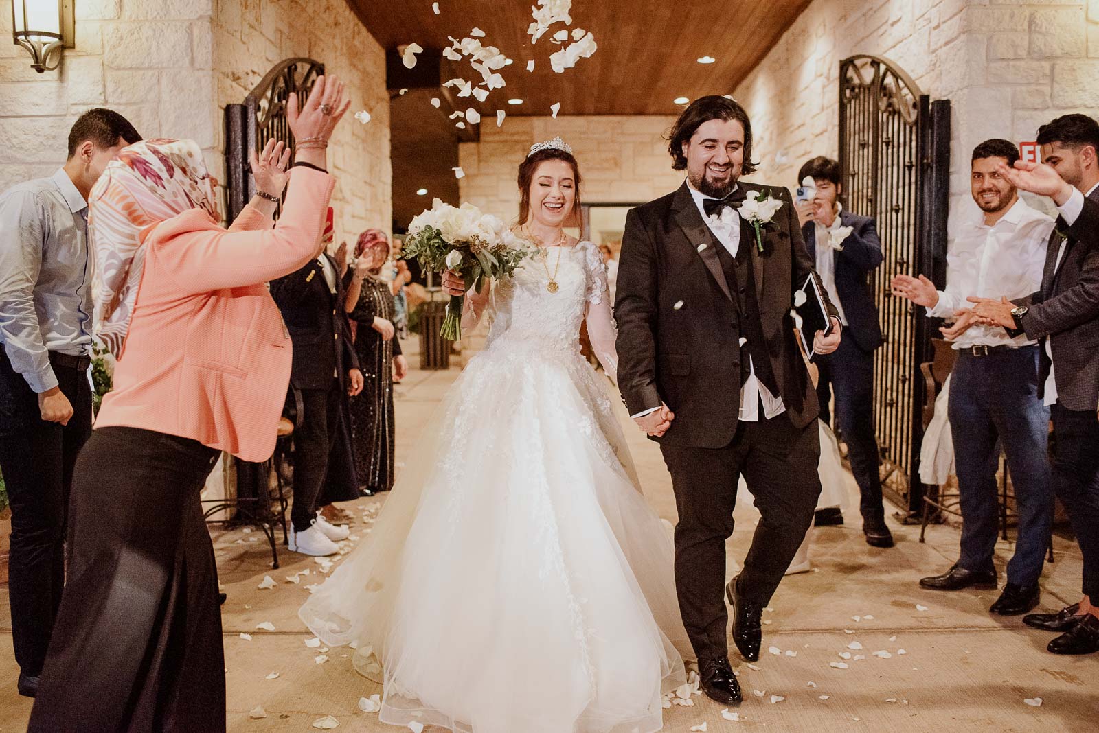 The bride and groom exit at Briscoe Manor in Richmond Texas