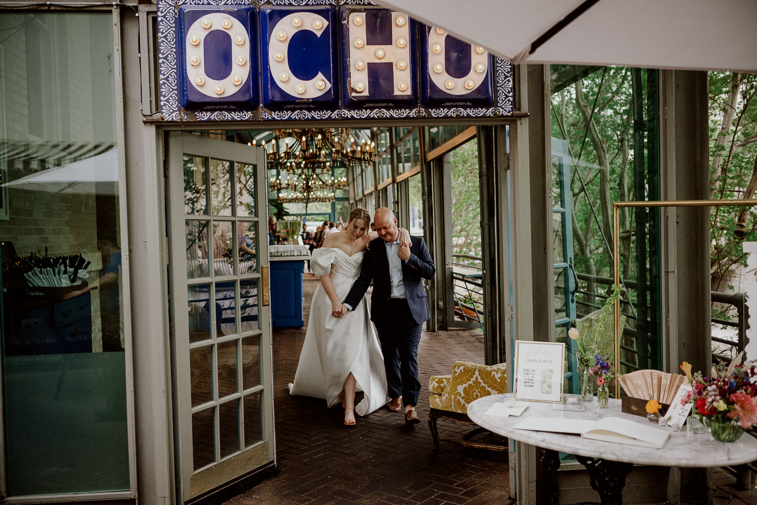 A couple exit Ocho at Hotel Havana just married and in a loving embrace